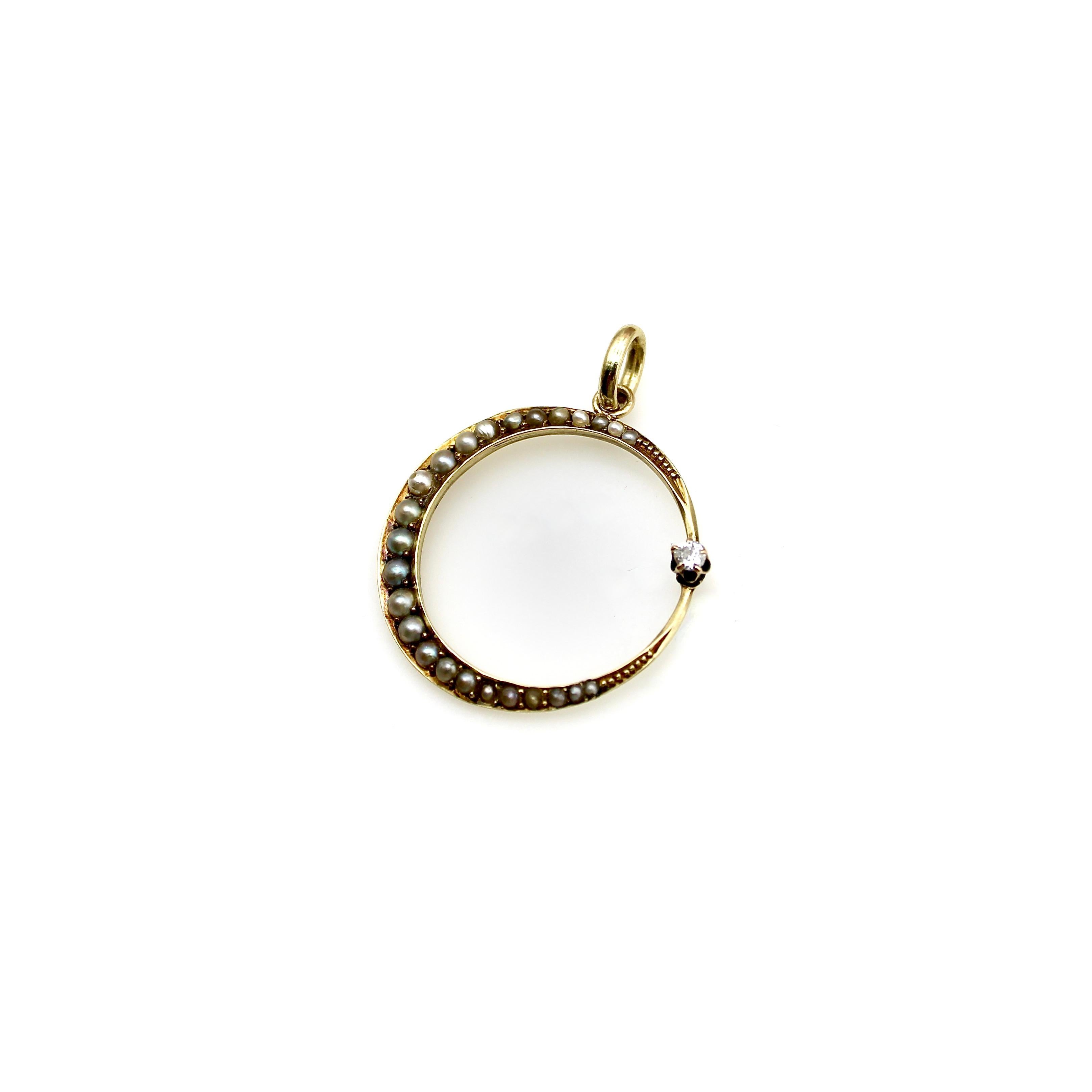 This 14k gold Victorian pendant makes a perfect circle--two edges of a crescent moon are enclosed by an Old Mine Cut diamond. Held in place by a five-prong setting, the diamond represents a star. The moon is dotted with seed pearls that descend in
