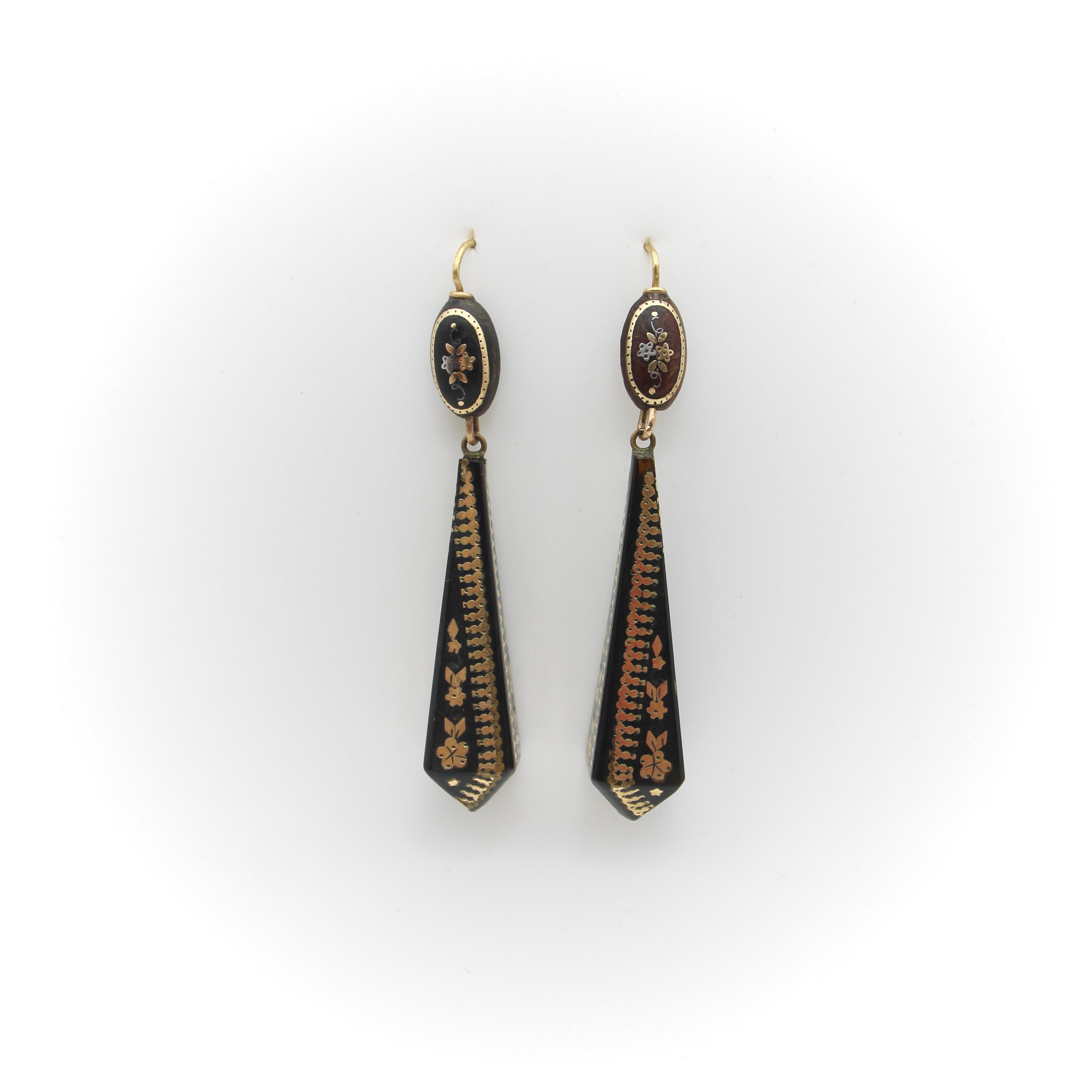 14K Gold Victorian Pique Geometric Dangle Earrings, circa 1880

These elegant Victorian pique drop earrings are inlaid with gold in a beautiful geometric design. Suspended from an oval top an elongated pyramid drop dangles creating a dramatic warm