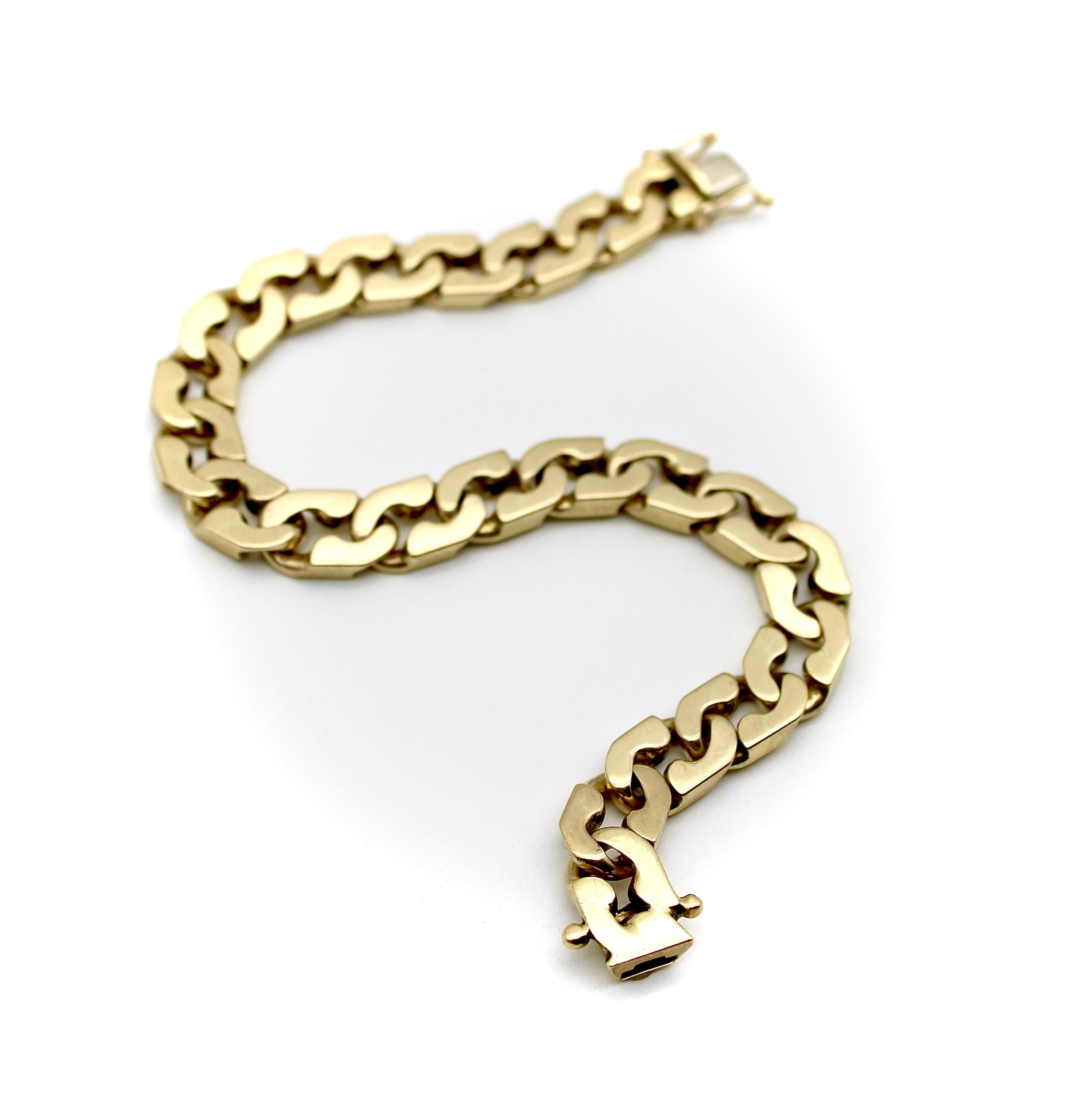 This 14k gold curb link bracelet is from Italy, circa 1980’s. It has a flattened design that gives a hard edge to the elongated curb links, allowing them to fit together like yin and yang. The links are notched so that they lie flat against the