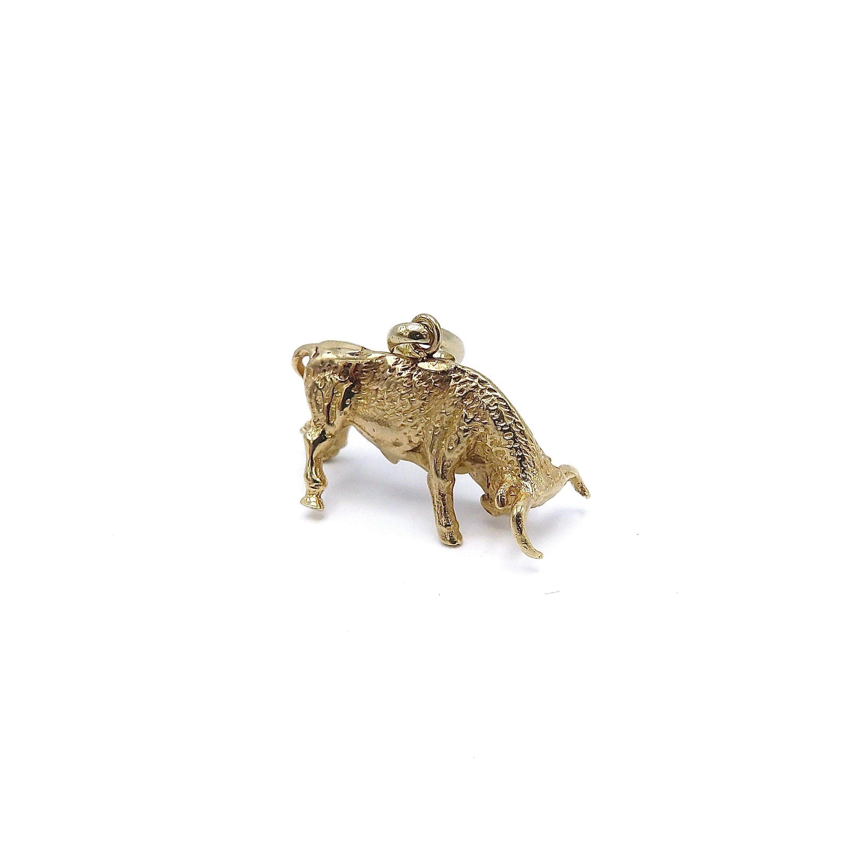 This small yet powerful 14k gold bull pedant-charm is realistically rendered with meticulous details throughout the body. Bulls symbolize stamina, strength, and power. They are also the symbol for the Taurus Zodiac, making them a great talisman for