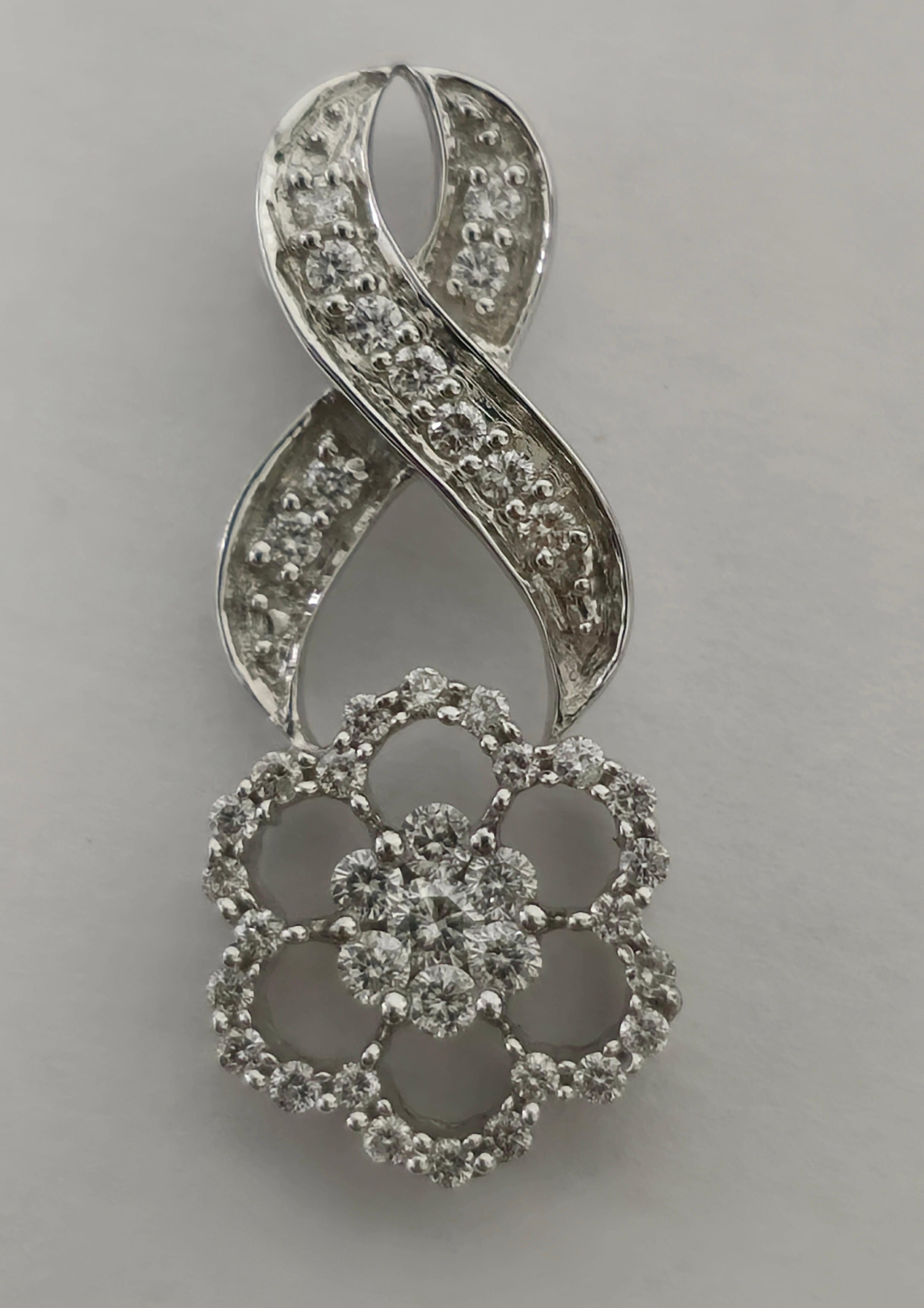 14K white gold. 
1.25 carat diamonds. 
VS-SI clarity and G color. 
Clean diamonds and excellent luster. 
Beautiful infinity design. 
Round brilliant cut diamonds. 
Vintage piece. 
Rare collectible diamond pendant. 
Excellent jewelry to gift at