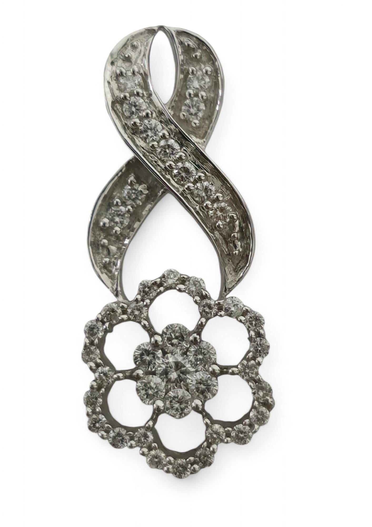 14K white gold. 
1.25 carat diamonds. 
VS-SI clarity and G color. 
Clean diamonds and excellent luster. 
Beautiful infinity design. 
Round brilliant cut diamonds. 
Vintage piece. 
Rare collectible diamond pendant. 
Excellent jewelry to gift at
