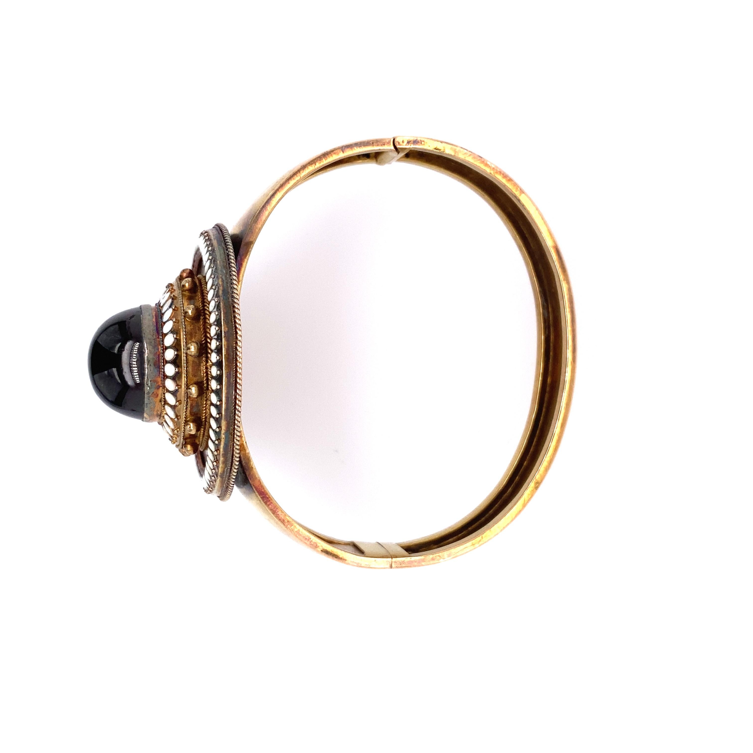 Victorian Era Circa 1890's. 14kt Gold White enamel and cabochon Garnet bangle bracelet. 
Total weight  17.0 dwt. Measurement of bracelet wrist is 6.50