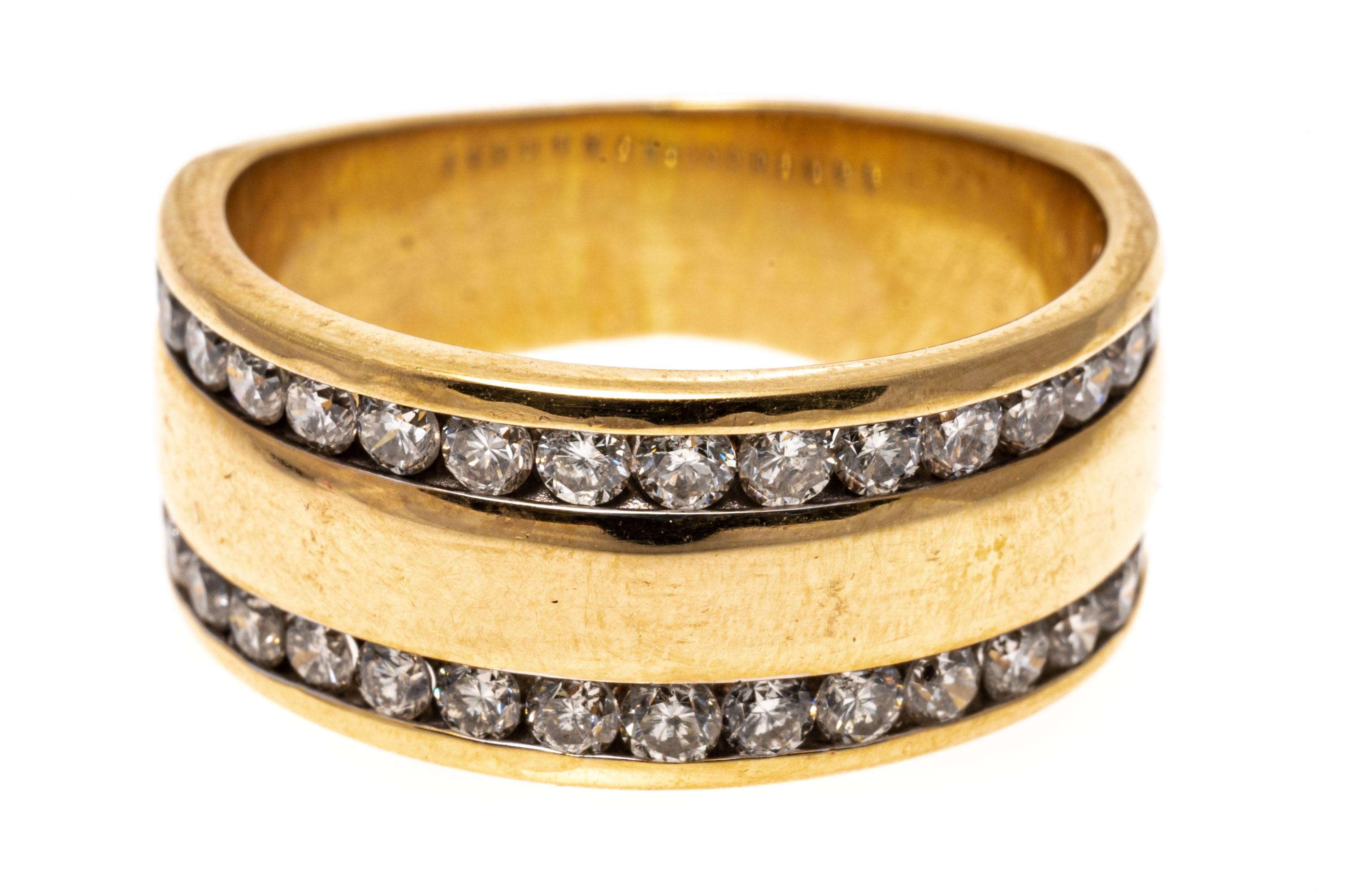 14k yellow gold ring. This stylish wide band ring is high polished, and decorated near the edges with a row of round brilliant cut diamonds, approximately 0.68 TCW, channel set.
Marks: 14k
Dimensions: 5/16