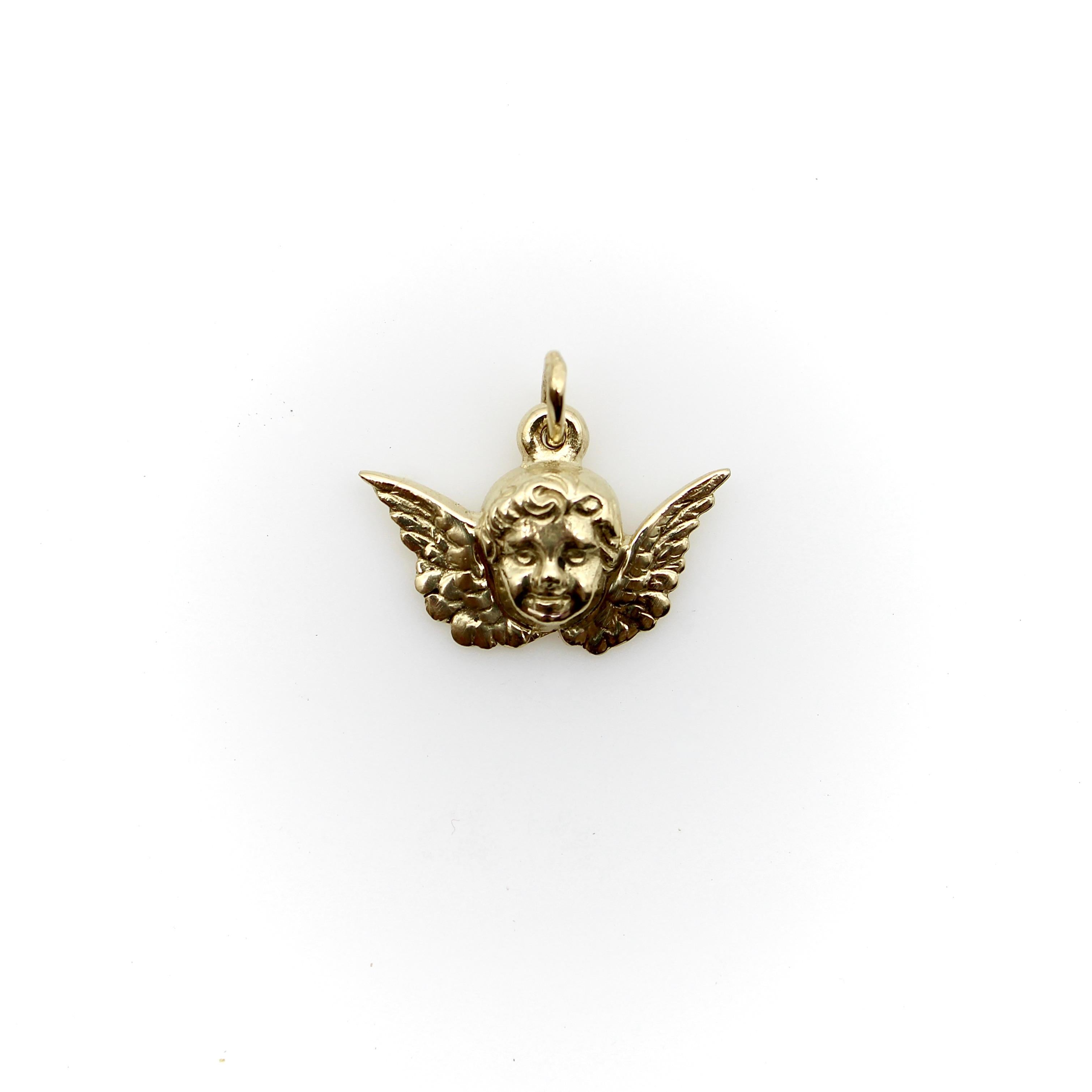 This winged cherub face stole our heart at Kirsten's Corner and had to become a signature piece. It is a Victorian inspired little putti, made of 14K gold. An incredibly detailed sweet baby face with flowing curls is framed by classic outstretched