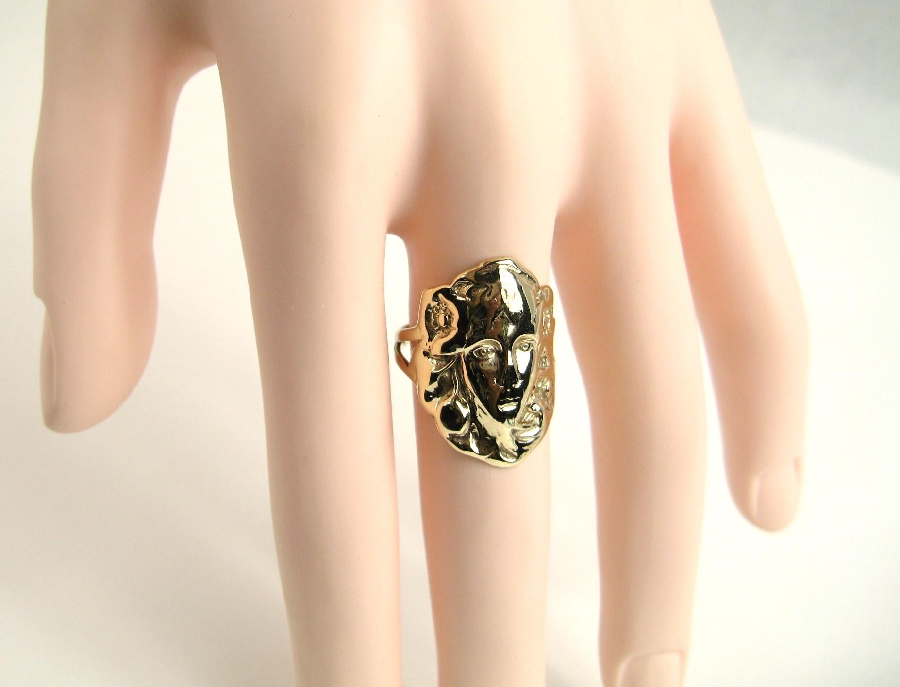 ART NOUVEAU Woman's face molded into a 14K Gold Ring.  measures a 1 in. top to bottom. The ring is a size 8 and can be sized by us or your jeweler. Be sure to check our storefront for hundreds of pieces of Fine, costume jewelry, sterling silver, and