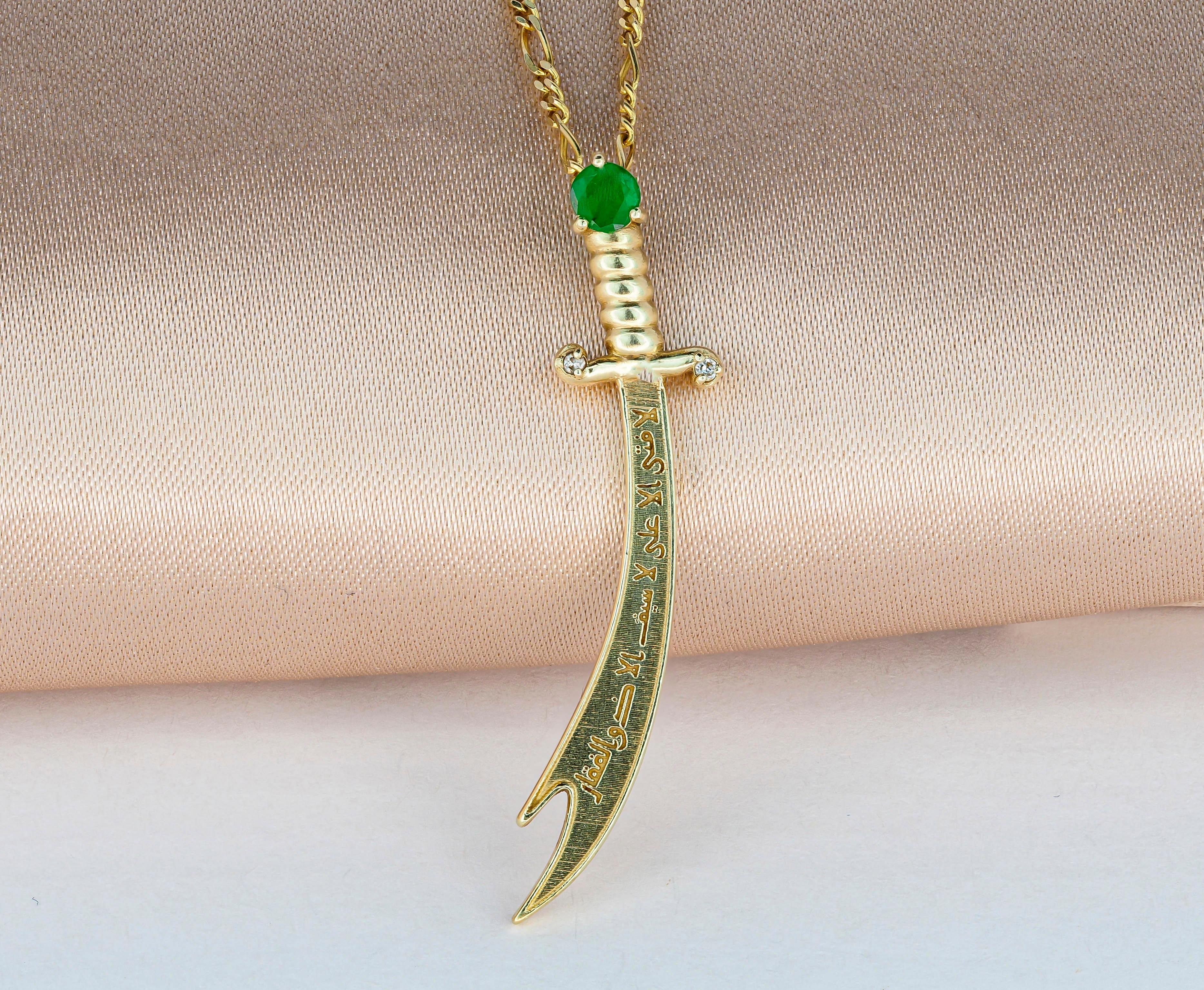 14K Gold Zulfikar sword pendant with emerald, diamonds. 
Shia Islamic Hazrat Imam Ali ibn Abi Talib علي Zulfiqar Sword. Emerald gold pendant.

Metal: 14k gold.
35x7.5 mm size.
Weight 1.70 gr.

Gemstones:
Emerald: round cut, green color, transparent