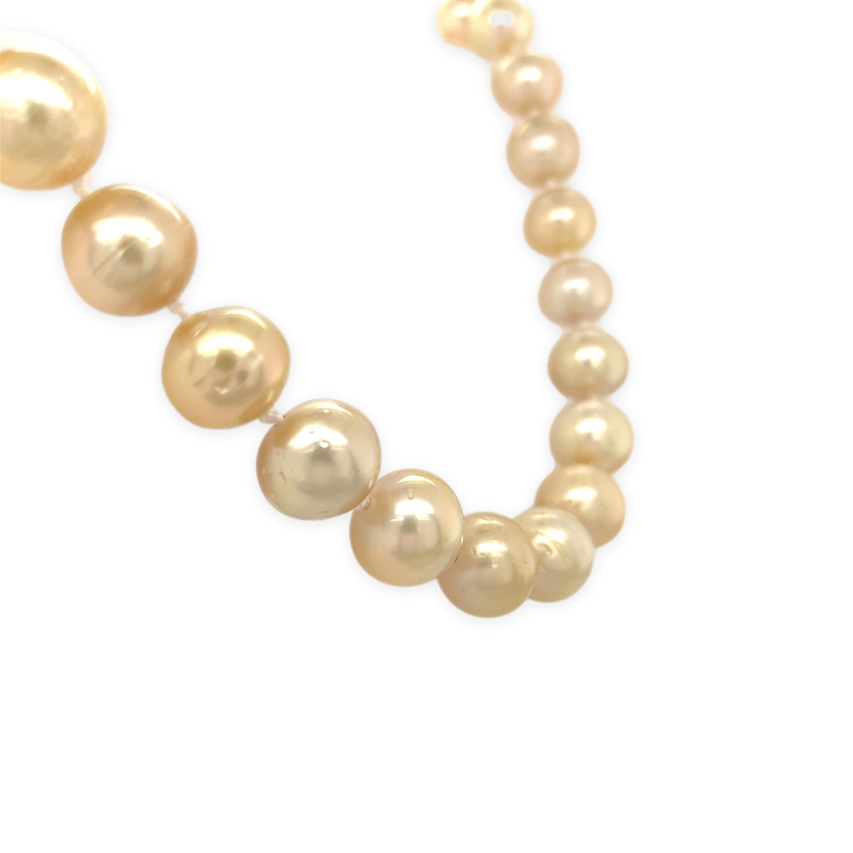 Strand of golden South Sea cultured pearls. The pearls are round to semi-round shape cultured in French Polynesia. Natural light golden color with some blemishes. The pearls measure 9-10mm. Freshly knotted and finished with a 14K yellow gold clasp.