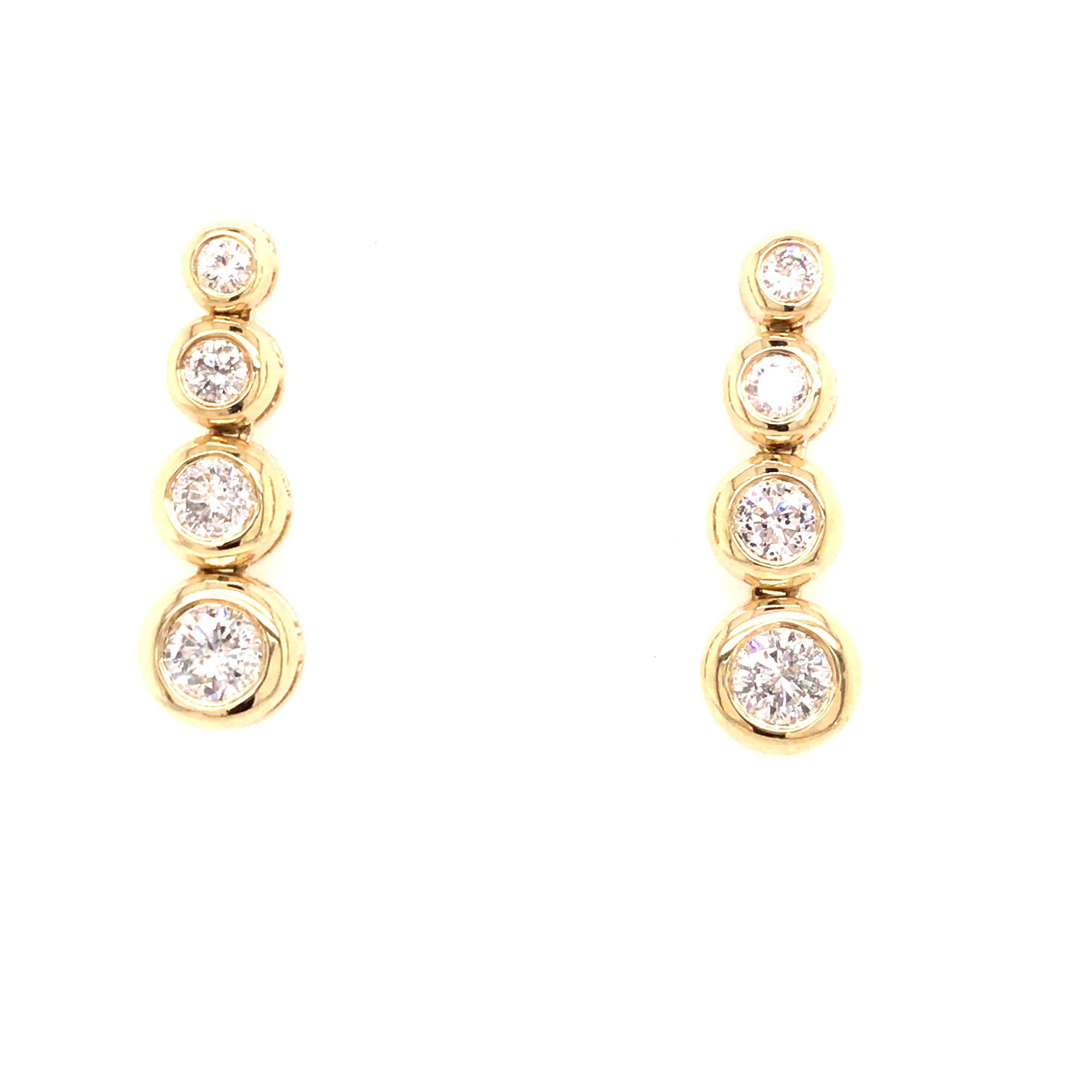 Graduated Diamond Bezel Set Earrings in 14K Yellow Gold.  (8) Round Brilliant Cut Diamonds weighing 1.82 carat total weight, G-I in color and VS-SI in clarity are expertly set.  The Earrings measure 15/16 inch in length and 5/16 inch in width at the