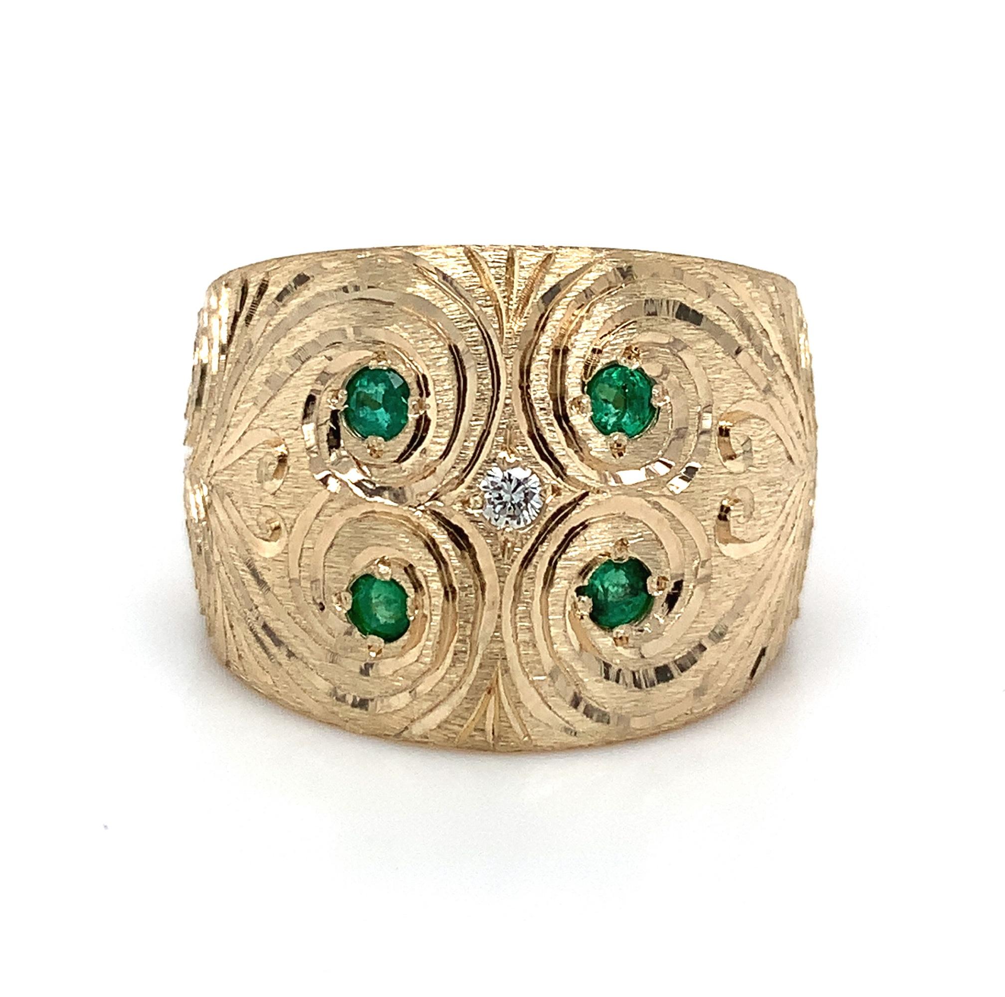 
14K yellow gold wide cigar band ring set with emeralds and diamonds. Our talented goldsmith recycled our scrap gold findings into this heavy gold band. He used a frosted/stone finish and hand engraved scrolls around the gemstones. The band weighs a