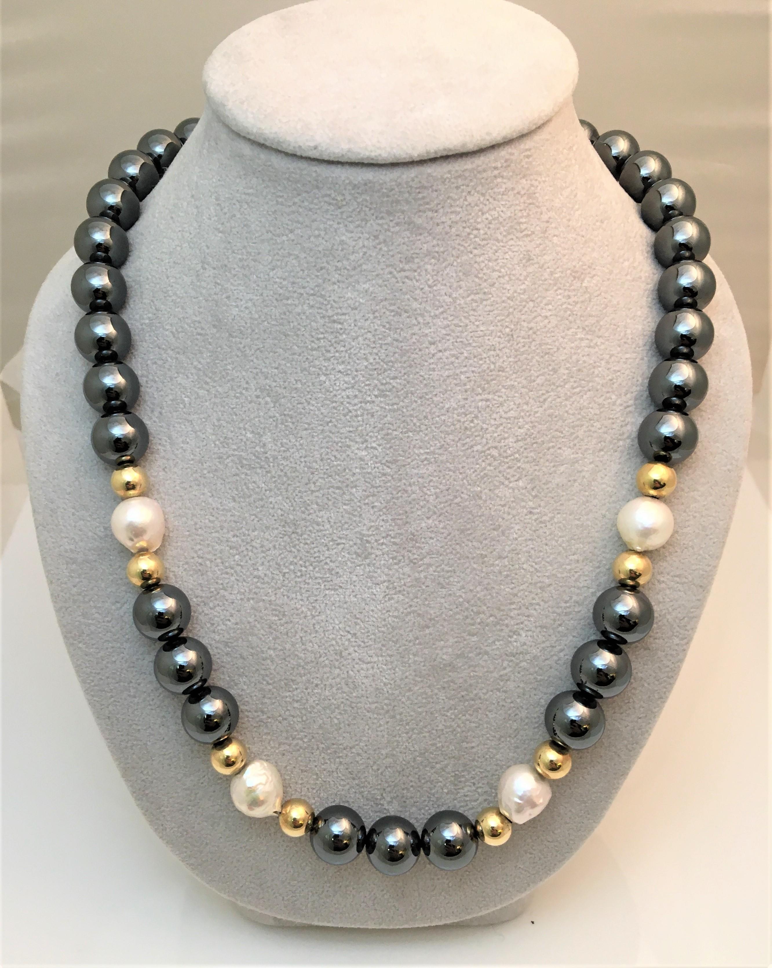 This is a one-of-a-kind necklace!   
Thirty three hematite beads, approximately 10mm each
Eight 14 karat yellow beads, approximately 7mm each
Four white pearls varying in size
14 karat yellow gold strong magnetic closure
Approximately 18 inches