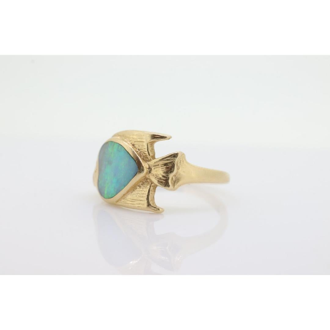 Vintage from the 1980s
Size: 5 1/4 US
Materials: Stone
Gemstone: Opal
Gem color: Blue

Band color: Yellow

Very rare ring by a popular jeweler. Made by KABANA. Hallmarked appropriately. 14k Yellow gold with a opal. Ring formed into a