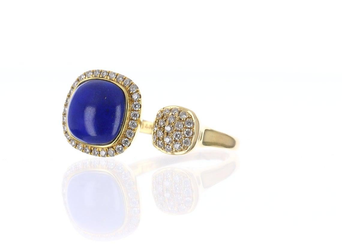 This is a stunning 14K yellow gold, diamond and lapis lazuli couture cuff statement ring. Absolutely stylish and sleek, ideal as a stand-alone piece or worn with other statement pieces. A cushion-cut lapis lazuli is inset yellow gold and has a pave