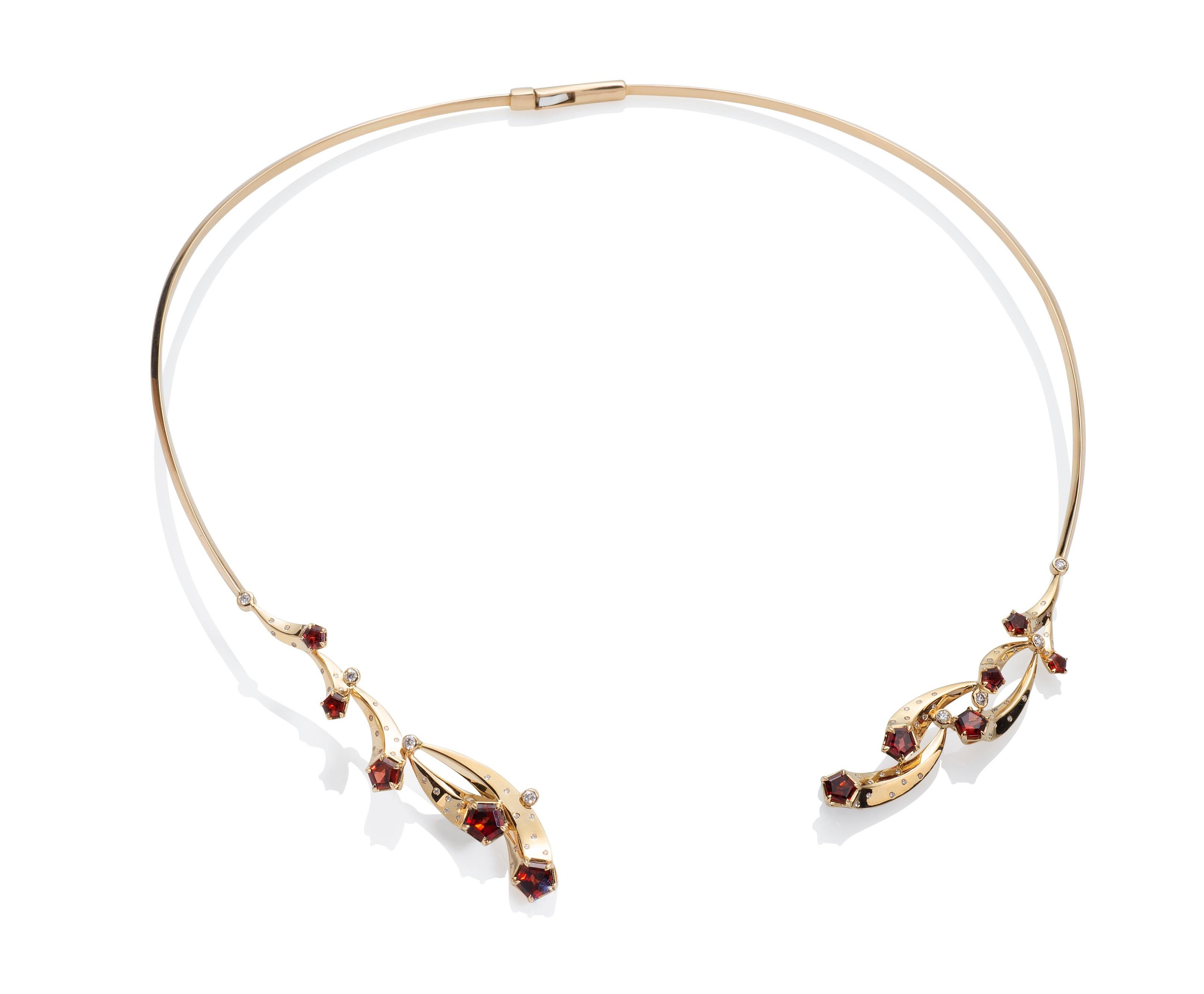 This is a very special necklace - made in 14k with Madeira garnets and diamonds. 
The joyful movement of this design is made with garnet comets, moving and playing. And that the necklace hinges in the back and opens in the front. Once the necklace