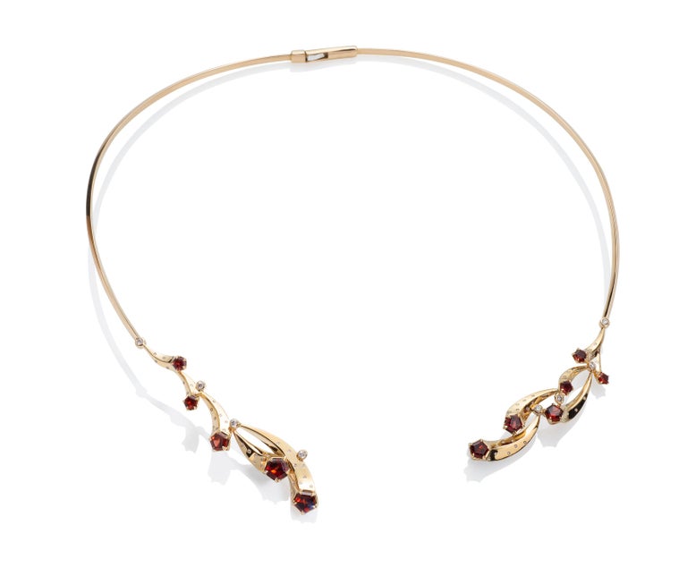 This is a very special necklace - made in 14k with Madeira garnets and diamonds. 
The joyful movement of this design is made with garnet comets, moving and playing. And that the necklace hinges in the back and opens in the front. Once the necklace