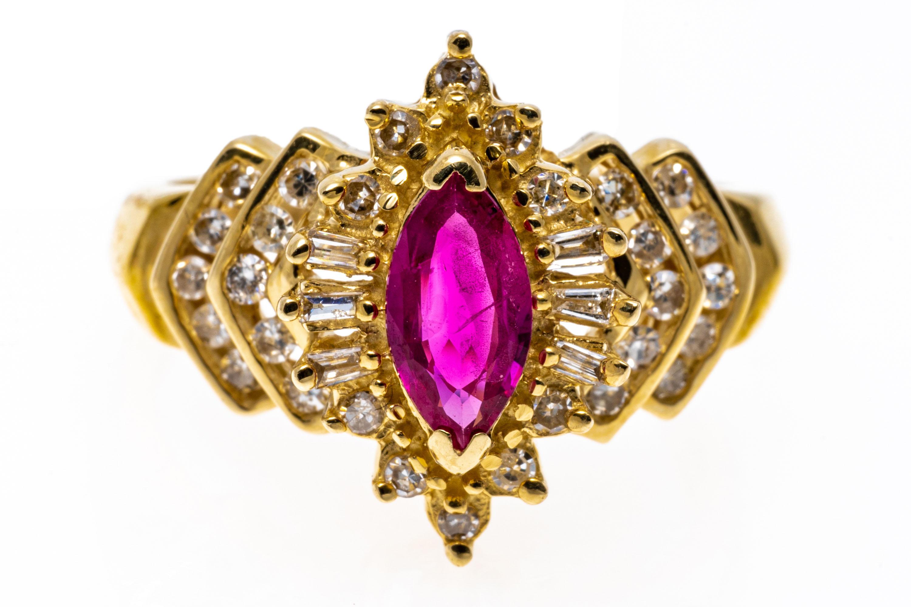 This ornate ring is a ballerina style, with a center marquise faceted, reddish pink color ruby, approximately 0.38 CTS, surrounded with a ballerina style baguette diamond frame, approximately 0.06 TCW, prong set, and flanked by chevron pattern