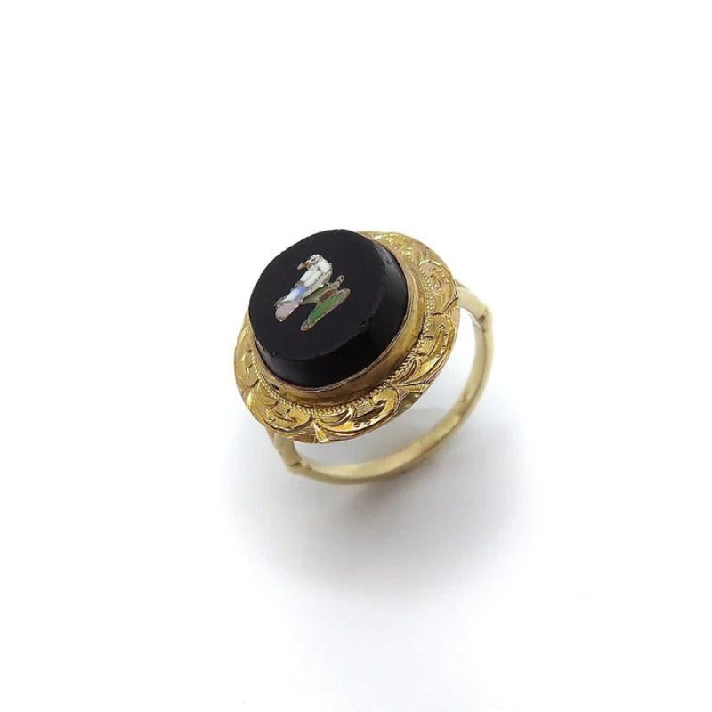 This is a beautiful 14k gold ring that is part of our Signature Collection. There is a 14k split shank that has been attached to a Victorian era micro mosaic bird set in a tablet of onyx and surrounded by a hand engraved 14k gold border. The onyx