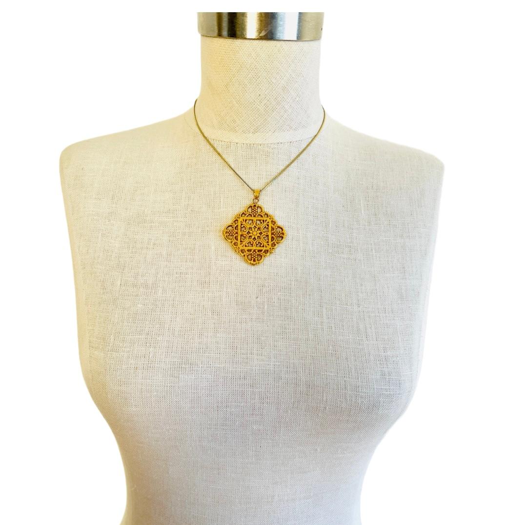 Large stunning 14k yellow gold pendant featuring open metal work in a diamond / cross shape. 

Size: 1-3/4