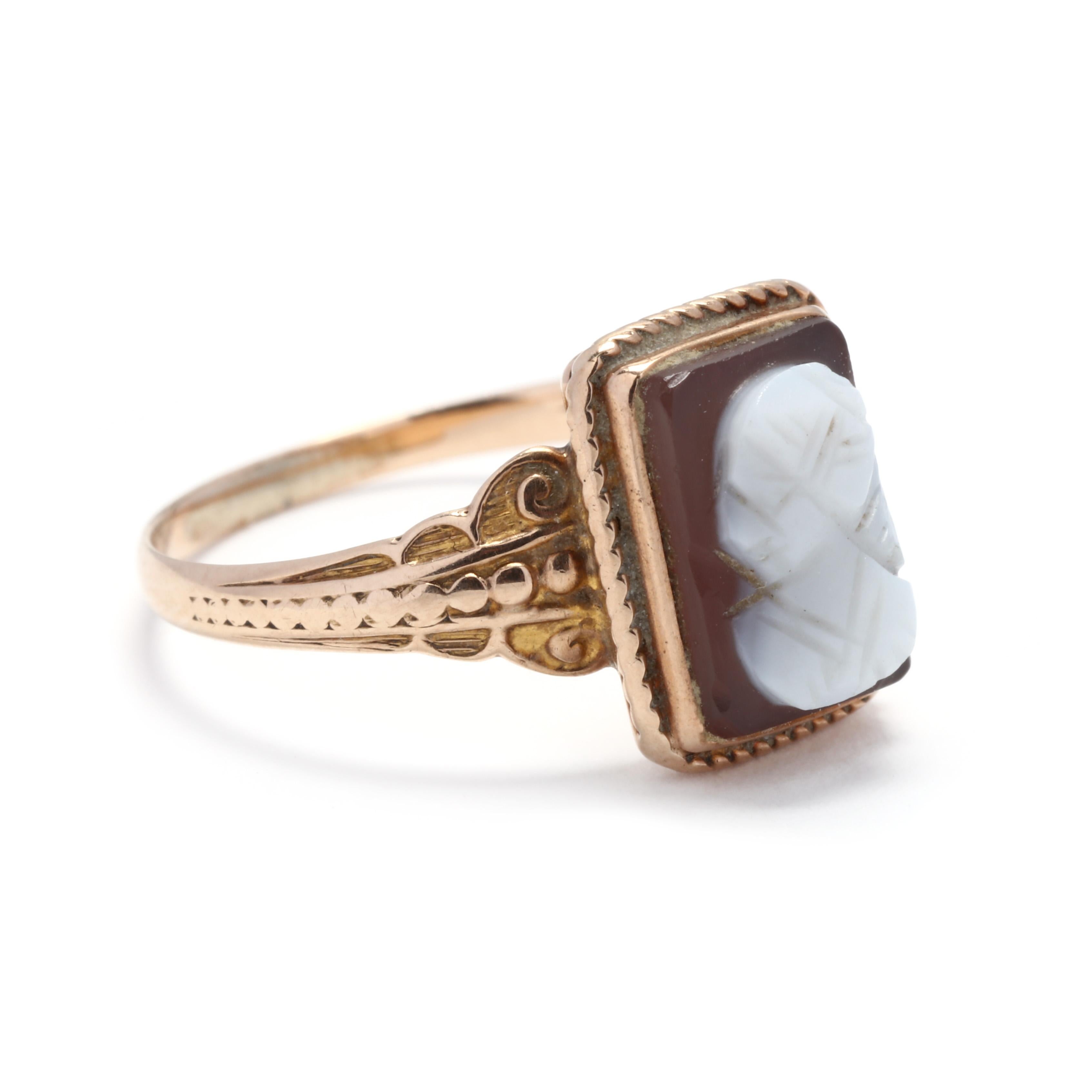 A 1930's 14 karat yellow gold rectangle cameo ring. This ring features a rectangular carved shell cameo depicting a female profile surrounded by a rope motif border and with an engraved, scaloped band.



Ring Size 5.75



Length: 3/8 in.



Weight: