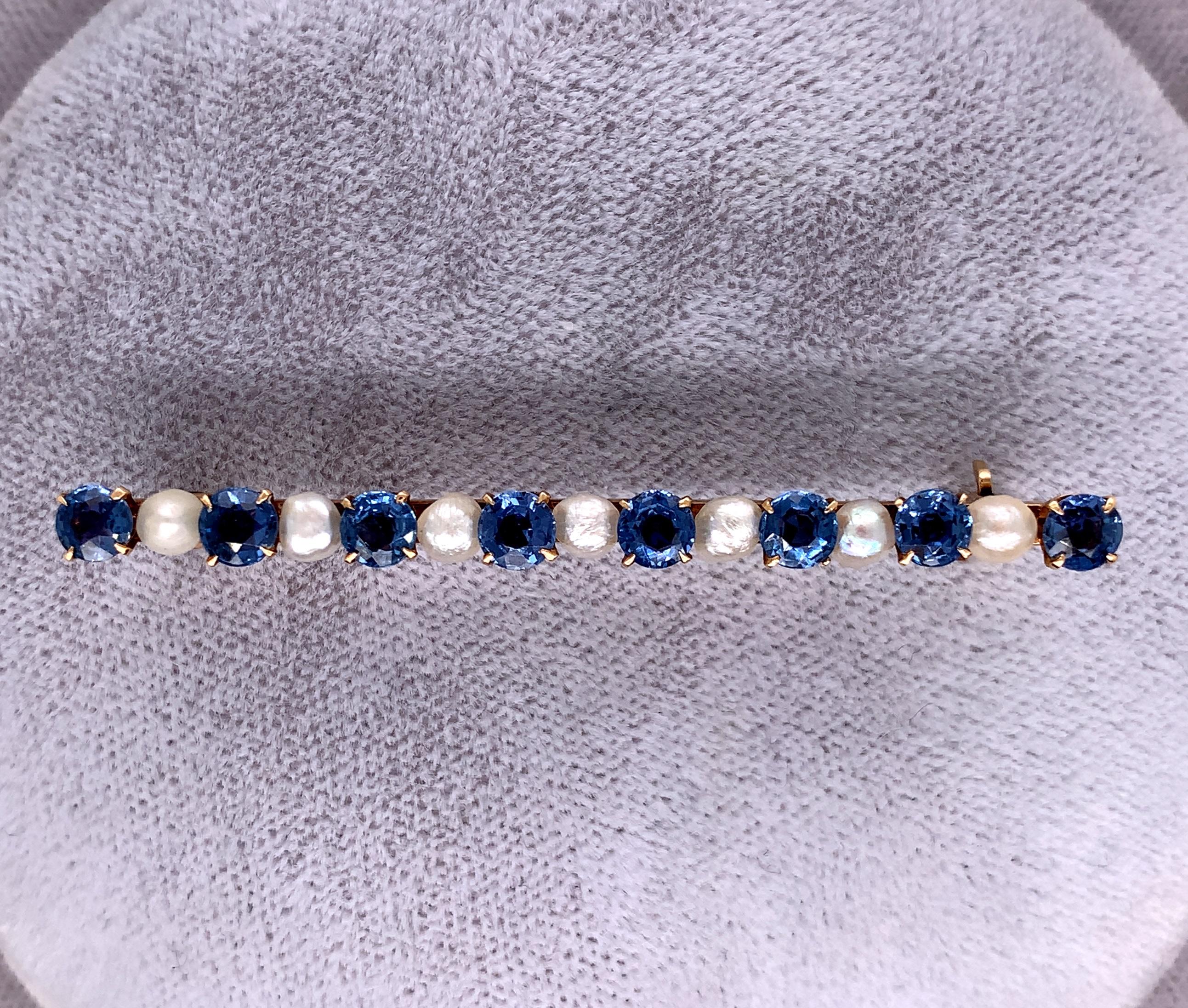  14K yellow gold Victorian bar pin with pearls and  round Montana blue sapphires. The sapphires have cornflower blue color with a hint of periwinkle. The pin measures 2