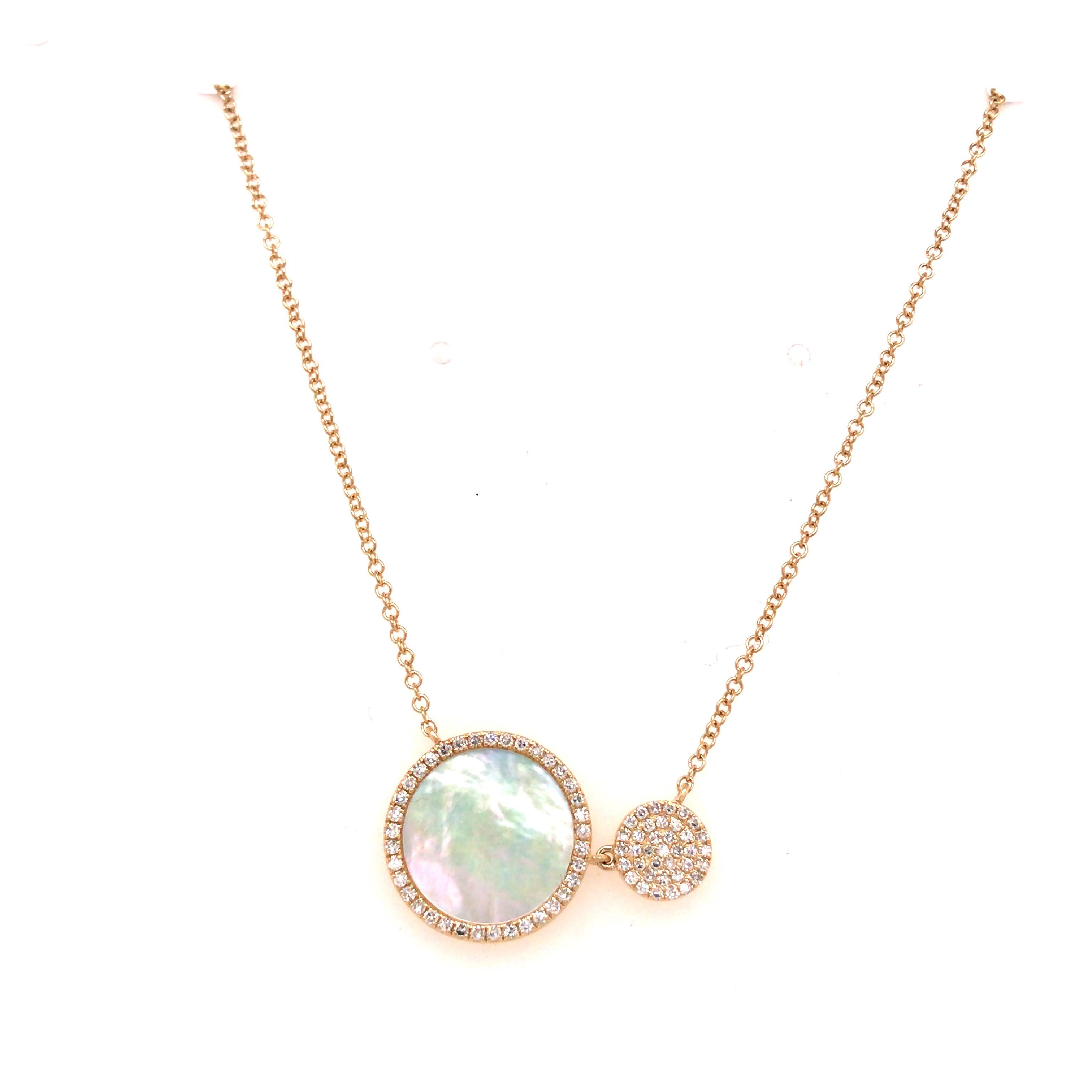 Mother of Pearl and Diamond Necklace in 14K Yellow Gold.  (74) Round Brilliant Cut Diamonds weighing 0.20 carat total weight, G-H in color and VS-SI in clarity are expertly set.  The double-circle Pendant measures 7/8 inch in length and 1/2 inch in