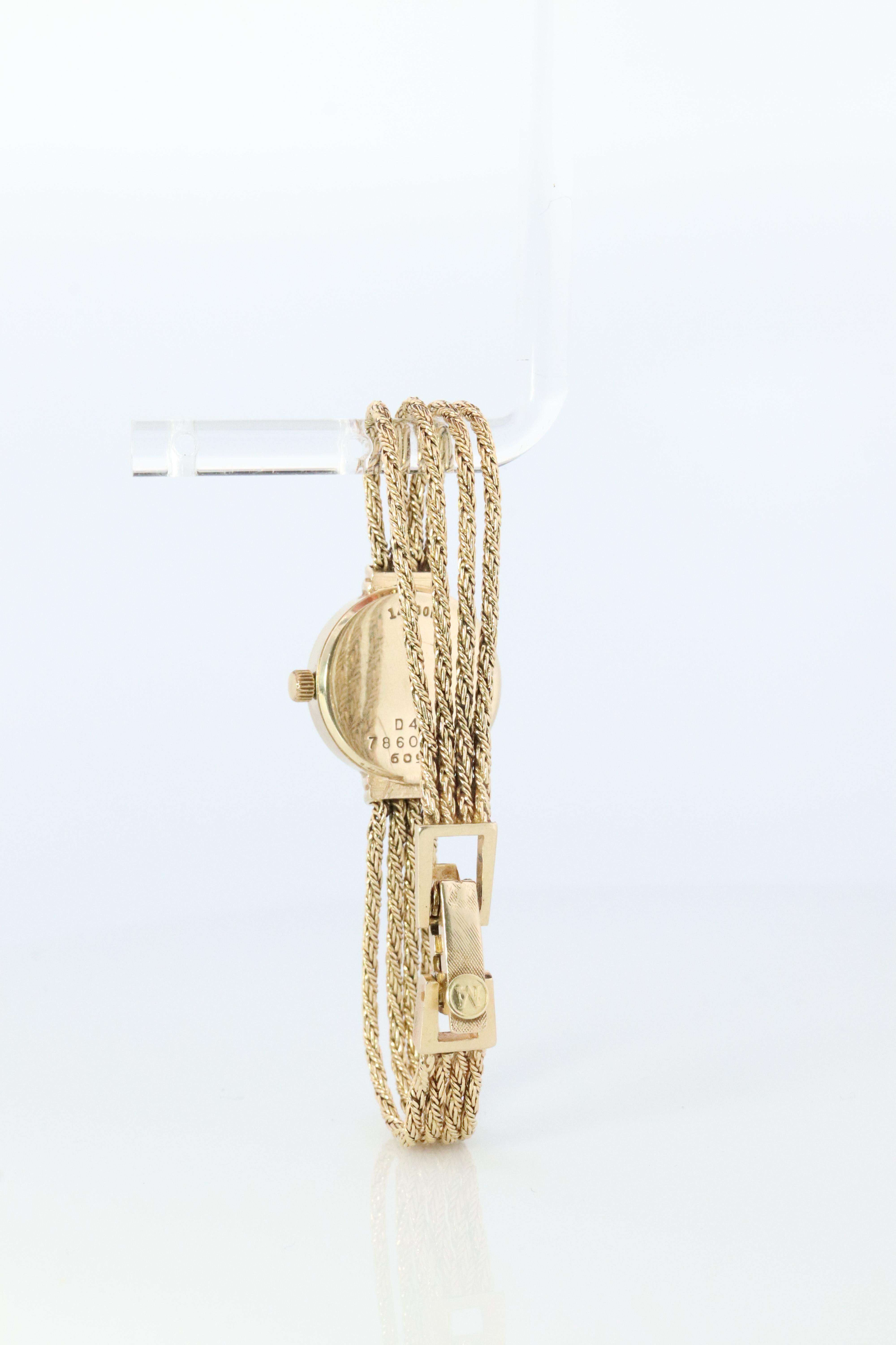 Classic  MOVADO 14k Watch. Black Dial.

The case is 14k Yellow Gold with a genuine Movado 14k Yellow Gold multiple strand rope Bracelet.
Ladies Round Case.

Quartz Movement. New Battery.

Details:
18mm round case
14k Yellow Gold Case and