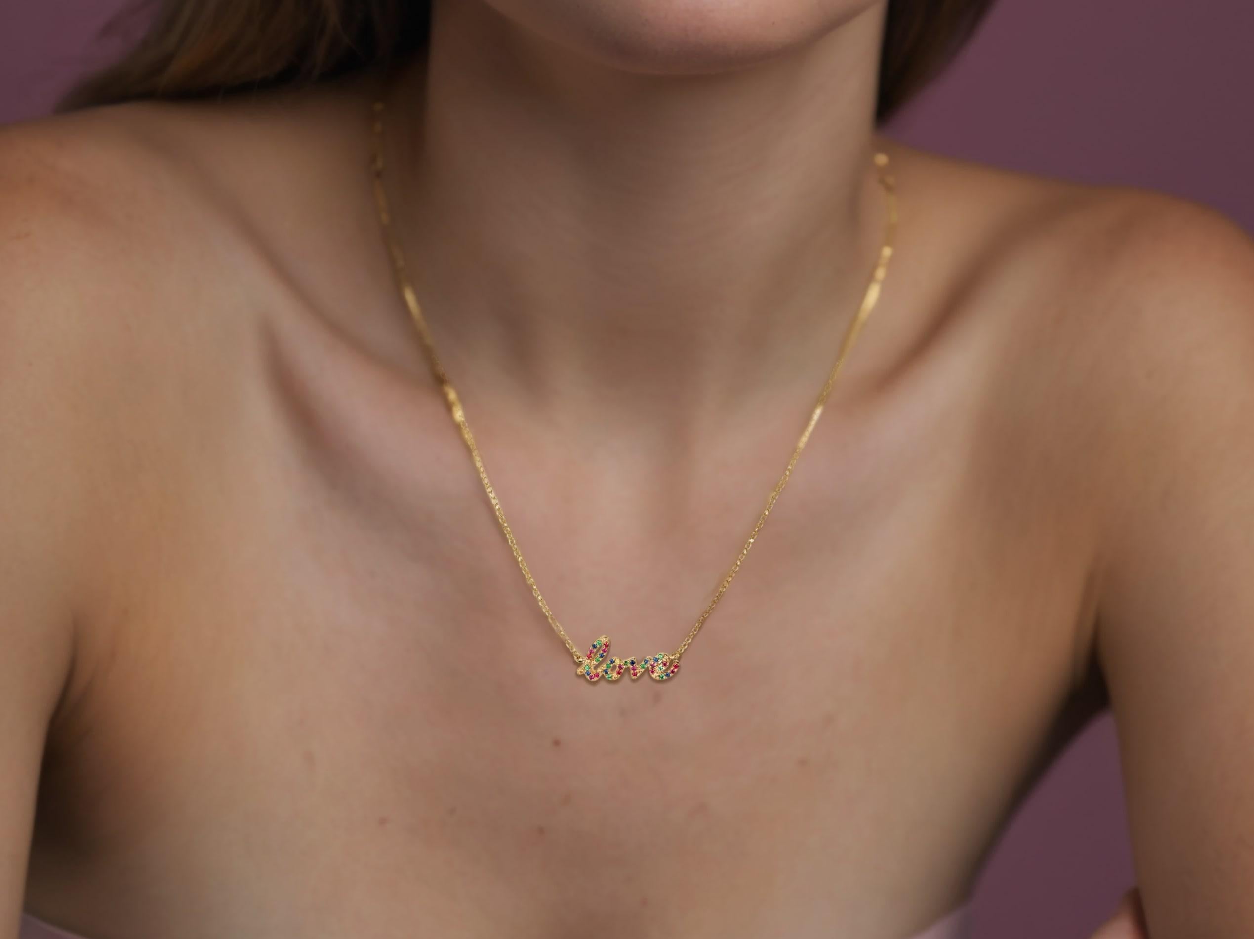 Celebrate love in vibrant style with our exquisite Love Script Pave Multicolor Sapphire 14K Yellow Gold Necklace. Featuring a delicate 14k gold chain adorned with a charming 'Love' pendant, each letter is beautifully set with sparkling,