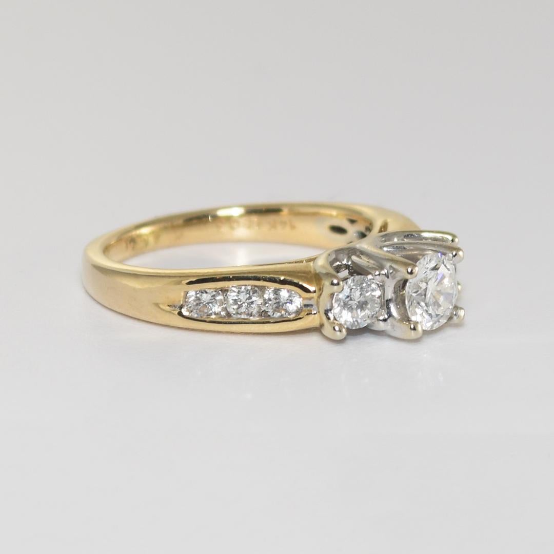 14K multi-tone gold ring weighs 5.0 grams.
The Center stone is .35ct, Clarity I1-I2, Color G-H-I, and eight smaller round cut diamonds on the sides, with a carat weight of 0.50. 
Clarity ranging from SI1-I1, Color G-H-I.
The ring is a size 6,