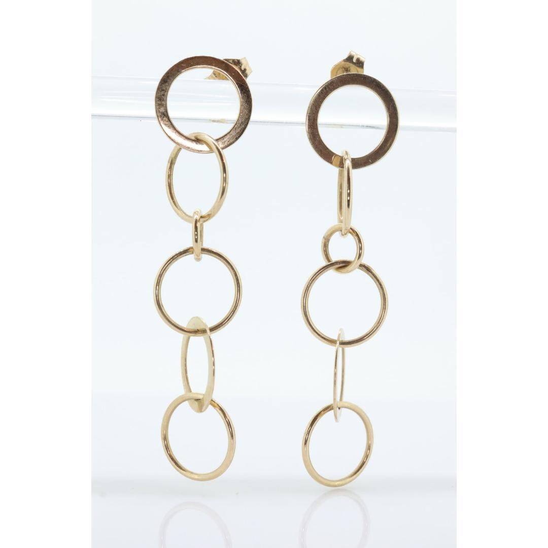 Donna Orecchini pendenti in oro 14k NABCO. Dischi a cerchi intrecciati in oro giallo 14k. in vendita