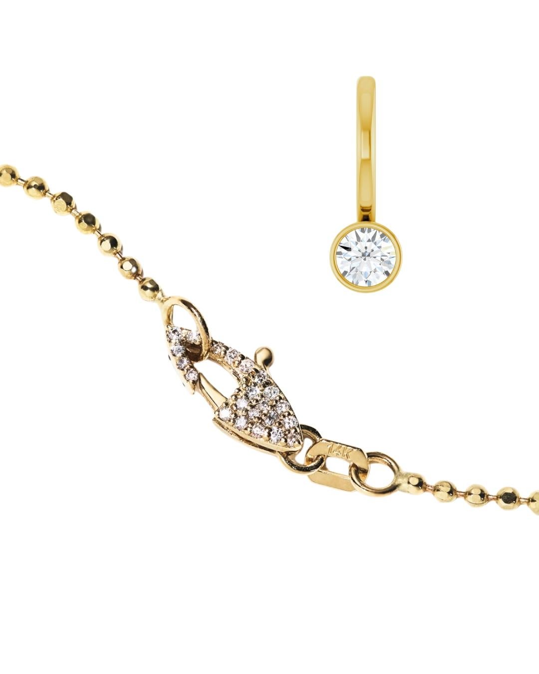 Meticulously crafted from solid 14k gold, this diamond-cut ball chain captivates with its intricate faceting that catches and reflects light with every subtle movement. Paired with our signature hand-pavé double-sided natural diamond clasp and