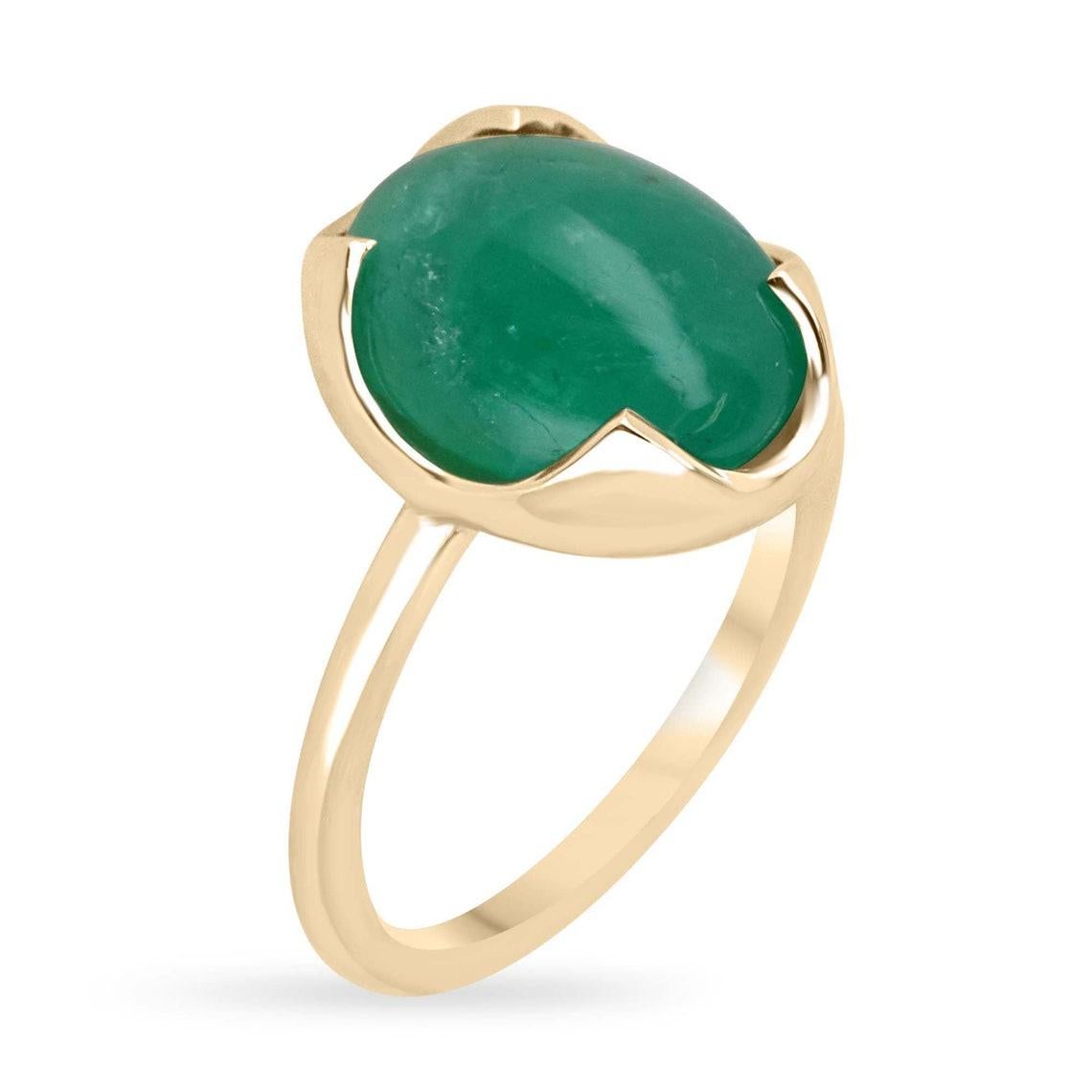 Elevate your style with our mesmerizing emerald cabochon solitaire ring, boasting a stunning 4.29-carat oval cabochon cut emerald sourced from the verdant lands of Zambia, radiating a medium dark green hue with translucent clarity. Embraced by a