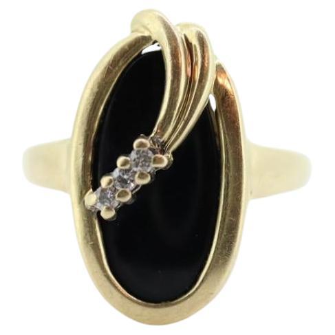 14k ONYX and diamond ring. Oval Onyx bezel set with tiny diamonds mourning ring