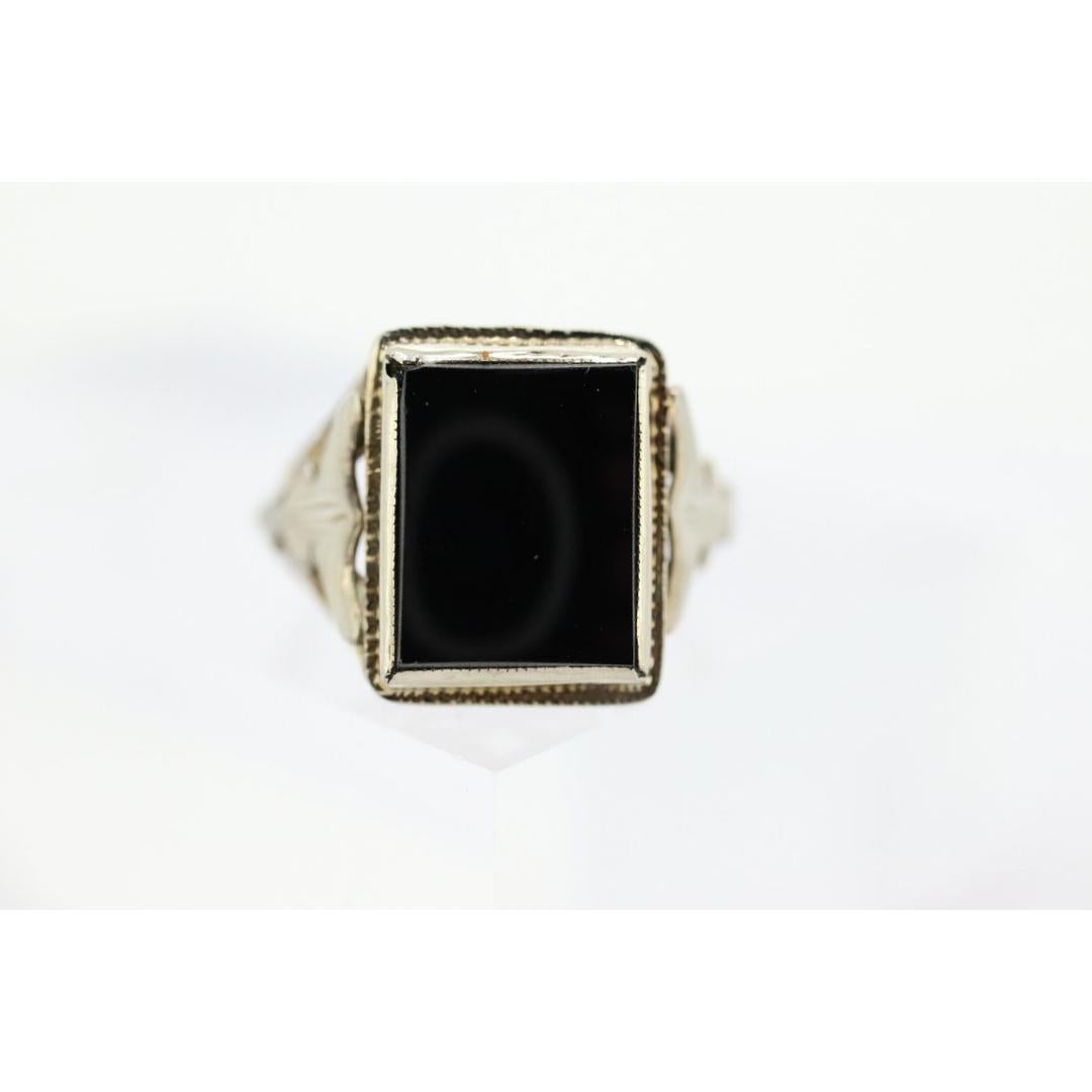 Vintage from the 1950s
Size: 3 US
Materials: Gold
Gemstone: Onyx
Gem Color: Black

Band Color: Gold

This is a super unique ring. Will work great for women and men alike. Excellent Pinkie ring. Modern slim design with Onyx bezel set into a picture