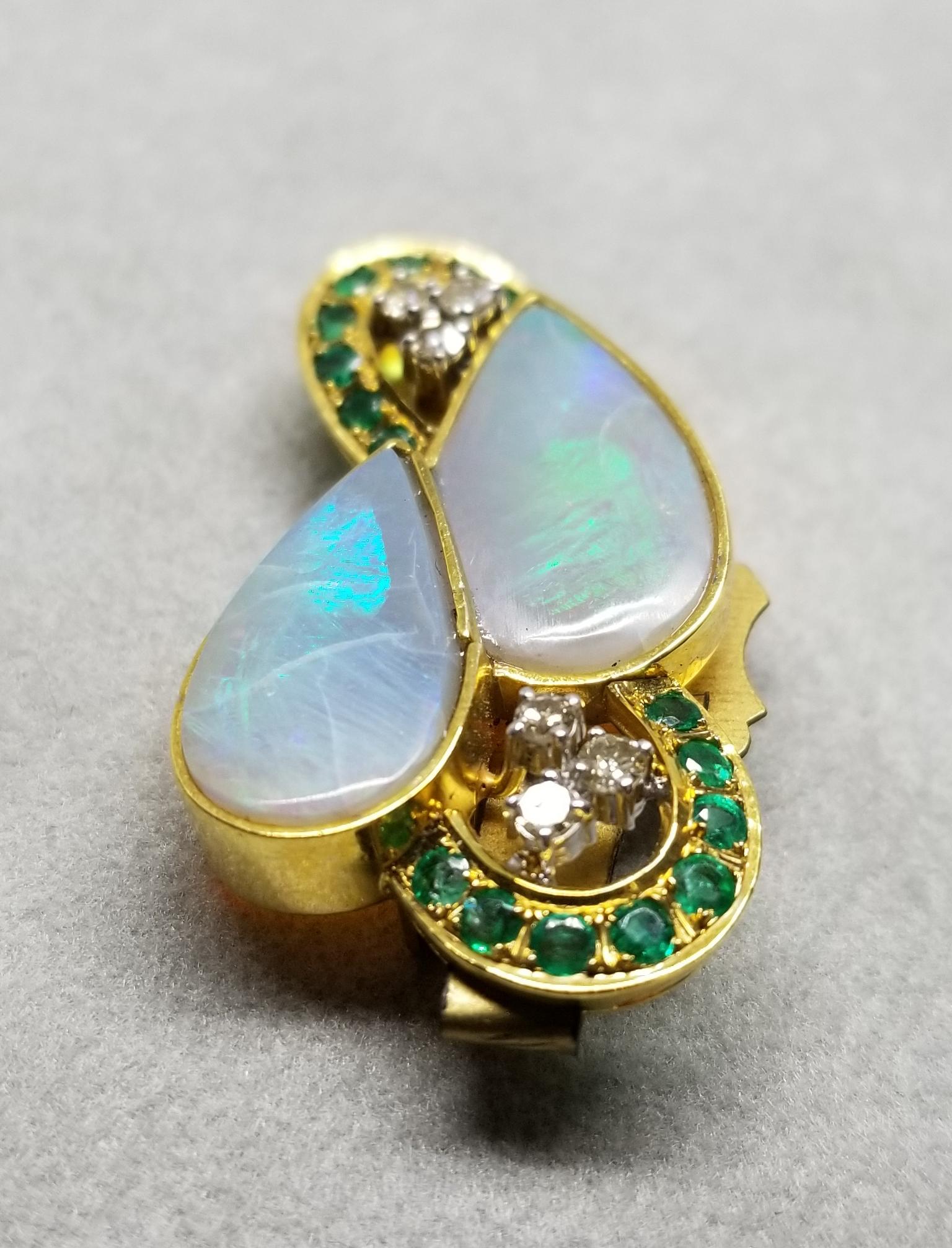 14k opal pin/pendant with 6 diamonds weighing .24pts. and 16 emeralds weighing .53pts. This piece of fine jewelry was designed and hand crafted by “Moshi” of New York, it was found in a vault from an estate sale and was never used.