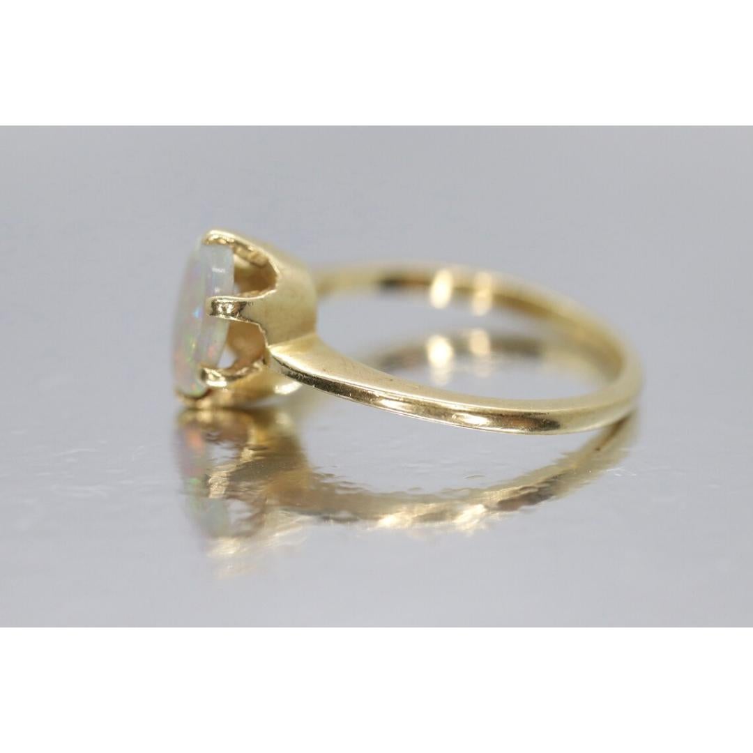 Vintage from the 1980s
Size: 5 US
Materials: Gold
Gemstone: Opal
Gem Color: White

Band Color: Yellow

A very clean, simple and dainty ring. Oval opal crystal prong set into a victorian claw.

Condition: Shows no to limited signs of