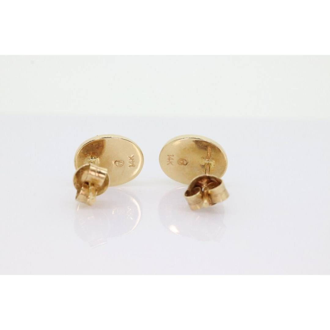Vintage from the 1960s
Materials: Gold

Gemstone: Ammolite

Stunning oval Ammolite set into 14k yellow gold. Stud earrings.

Ammolite has Green, Blue, Black, and Orange colors with Good light. It is bezel set into a modern style ring.

Details
8mm