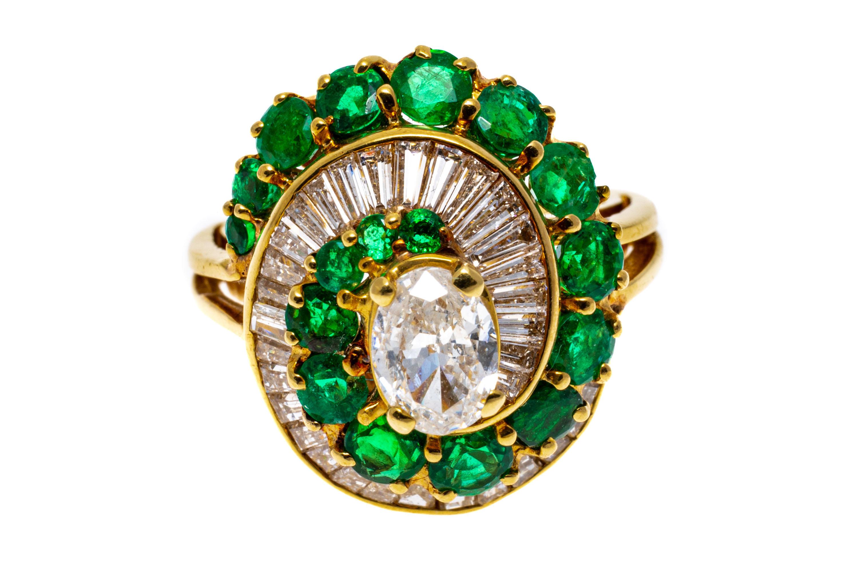 14k yellow gold ring. This amazing ring is a spiral of graduated, round faceted, bright green color emeralds, approximately 1.18 TCW, prong set, and alternating with a row of graduated baguette cut diamonds, channel set, approximately 0.56 TCW. Set