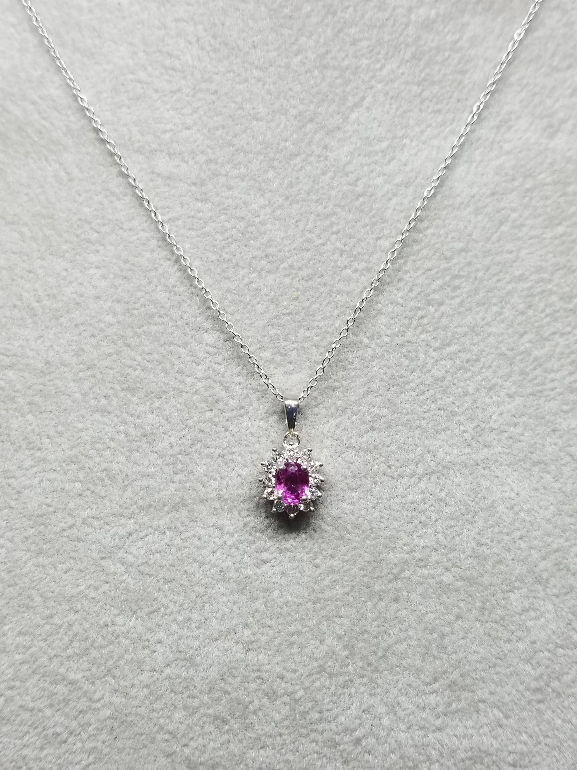 18k white gold oval pink sapphire weighing .47pts. and 12 round full cut diamonds of very fine quality weighing .15pts. on a 14k white gold 16 inch chain.
*pick a gemstone for the center*
