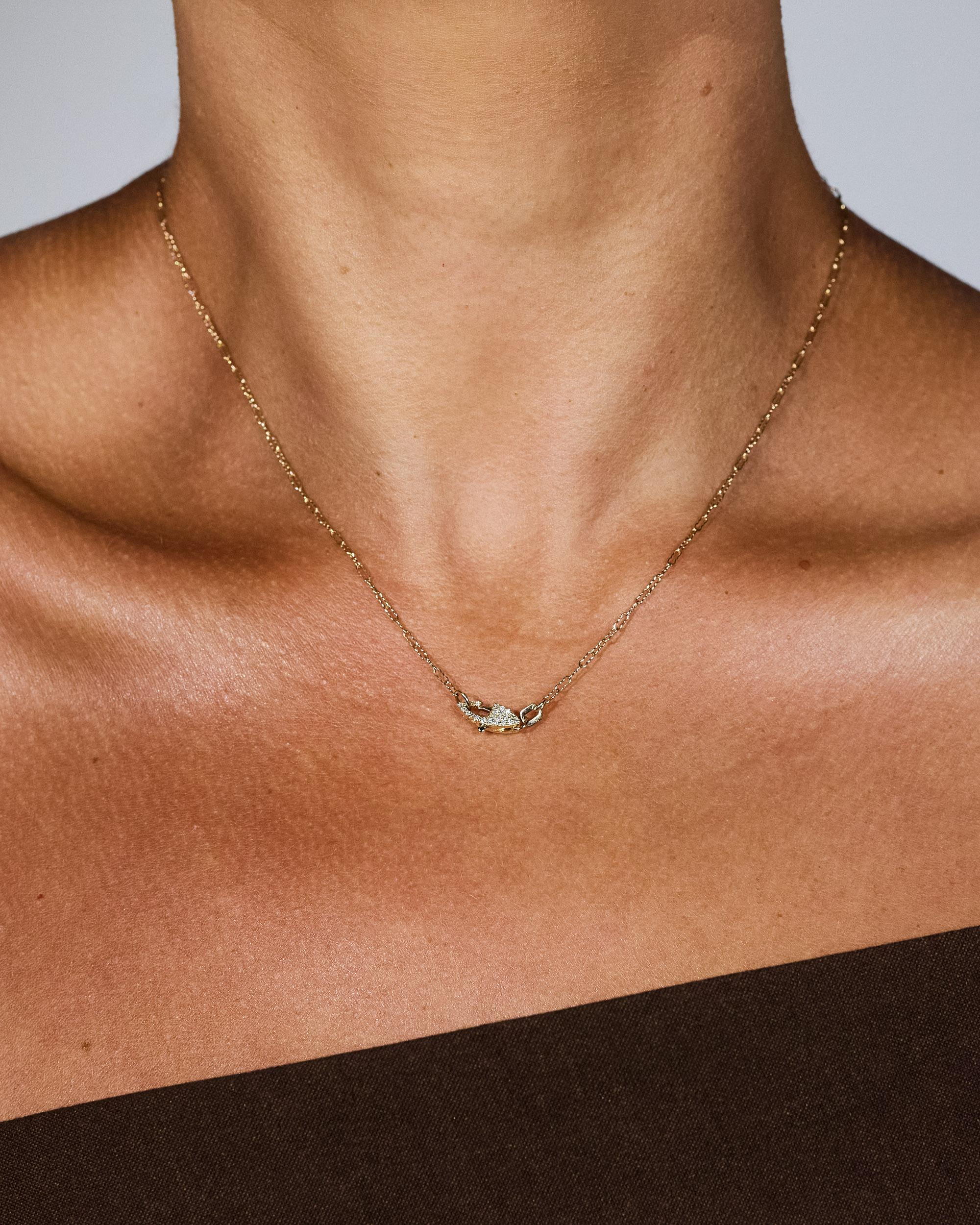 A solid 14k gold textured paperclip chain featuring a custom hand-pavé double-sided diamond clasp. We designed this style to stand out from the average paperclip chain. It’s minimal and a guaranteed conversation starter. Can be styled with the