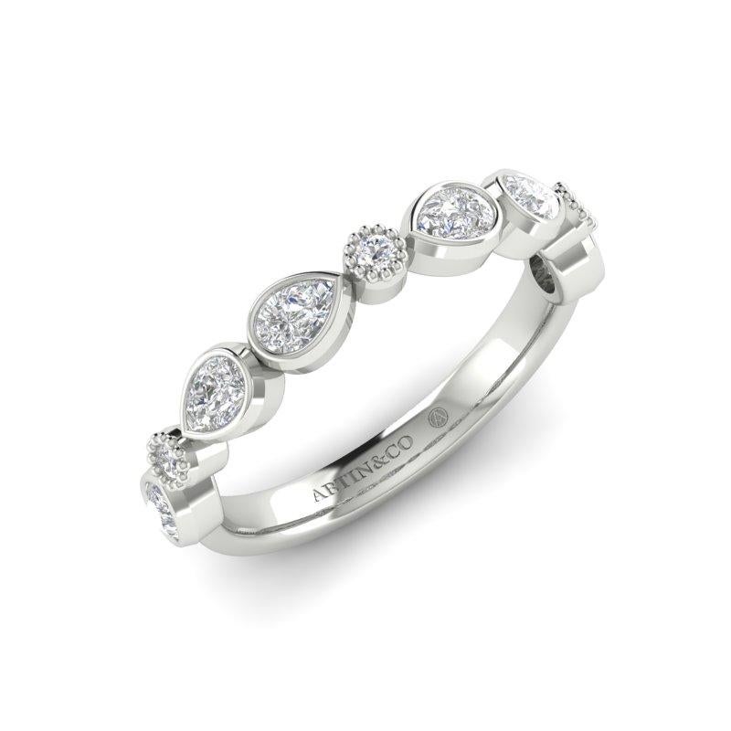 Crafted in 14K gold, this ring is a stunning addition to any jewelry collection. Featuring bezel-set pear-shaped & round diamonds this unique diamond band is a beautiful symbol of everlasting love and is sure to dazzle. Designed and manufactured in