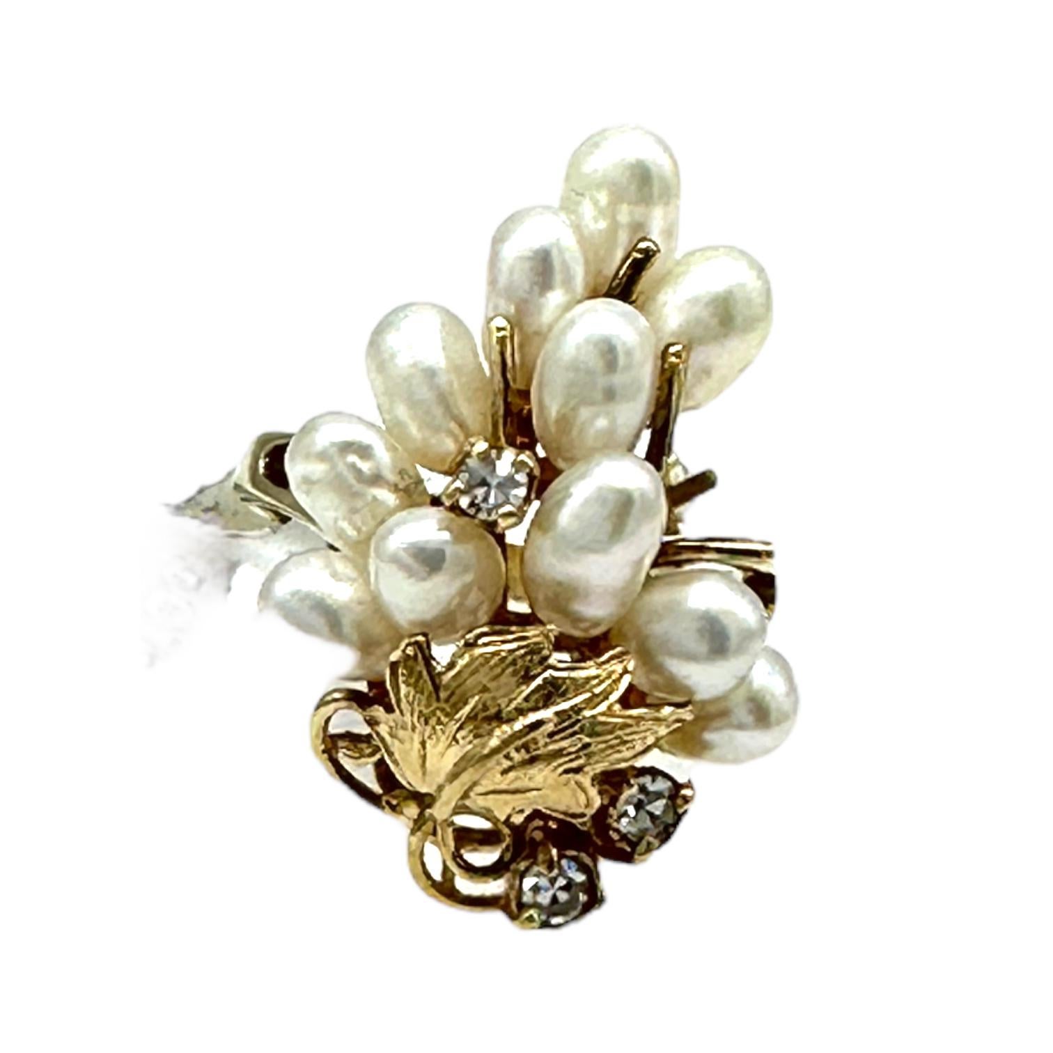 14-karat yellow gold pearl ring measures 23 x 16 mm wide and consists of three diamonds and freshwater pearls. The ring size is 5. The weight of gold is 4 grams. Three diamonds have a weight of .10 carats.
This necklace features a stunning cluster