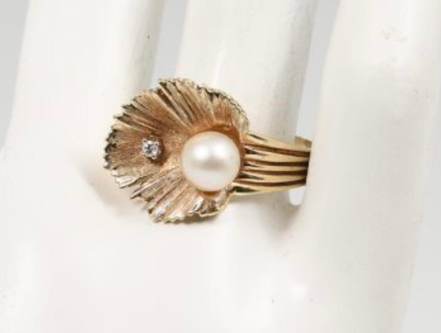 14K Pearl And Diamond Ring. 14K yellow gold ring contains 1 round brilliant cut diamond. WEIGHT: .02 Ct. Approx. Rated SI in clarity and H-I in color.  One 7.00 mm cultured pearl is epoxy set. the diamond is prong set. Weight: 5.7 grams.  Size: 10