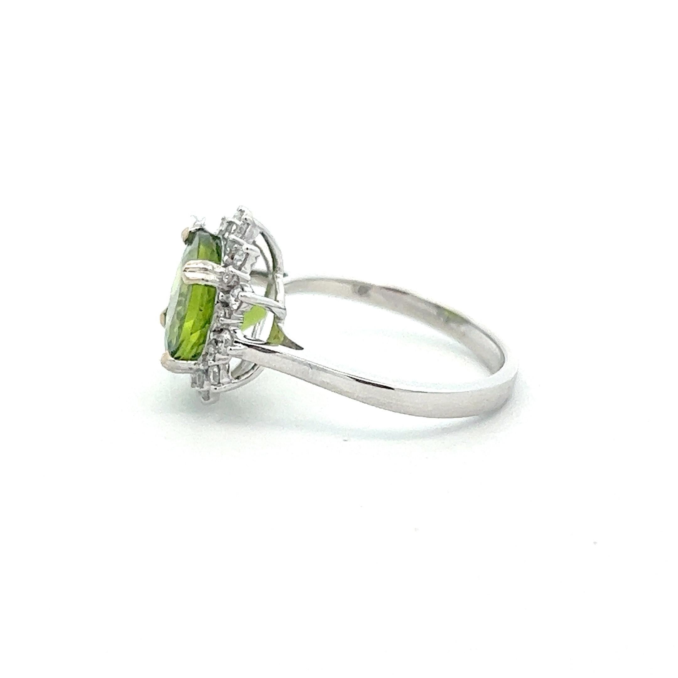A wonderful 3.24 carat peridot stone set within a halo of diamonds in 14k white gold. The peridot came straight from the Peridot Mesa Gem Mine in Peridot, Arizona and has a unique round cut that reflects light well. The ring is brand new and a size