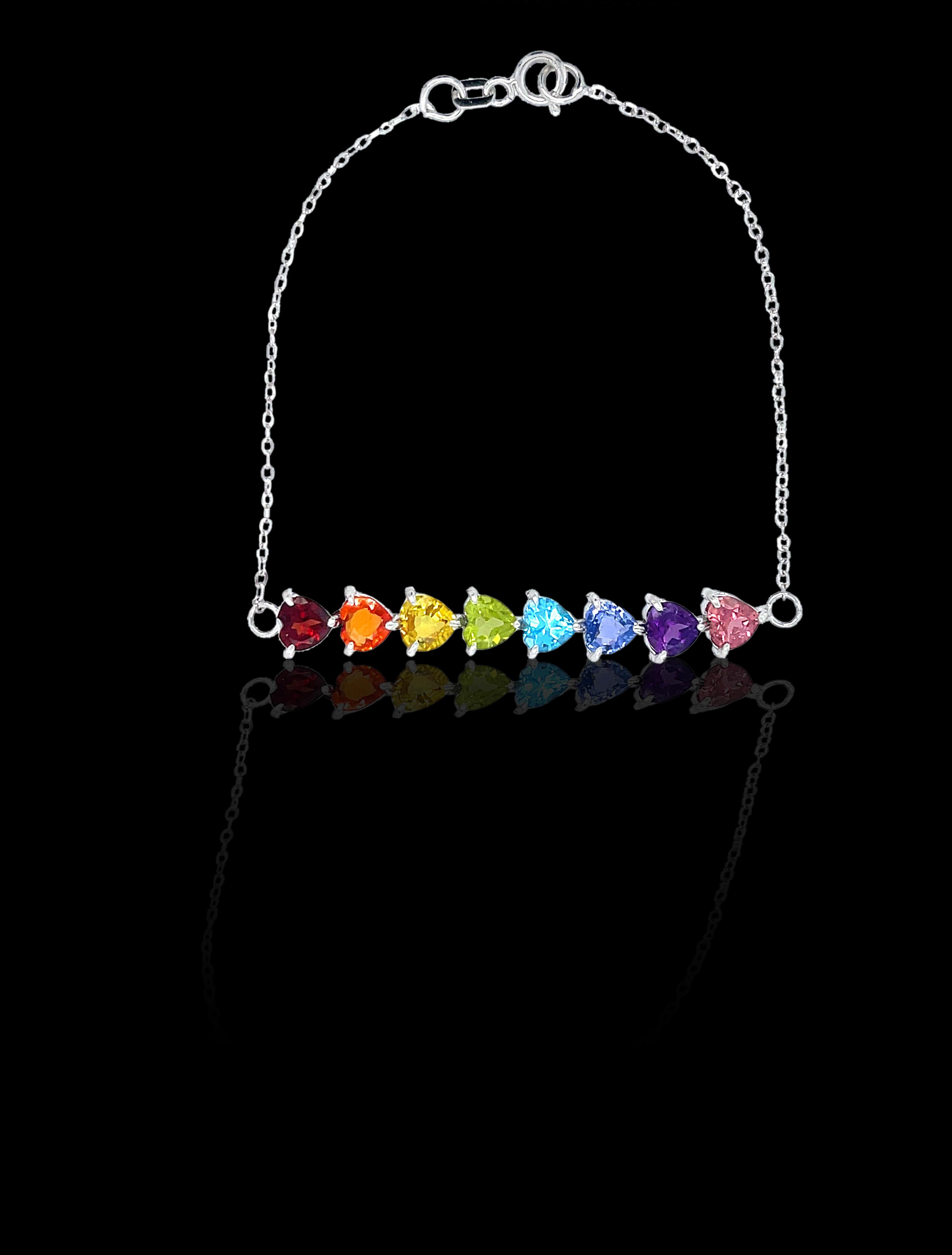 The full rainbow fantasy in the most unique and colorful bracelet to light up your life! 8 gems in the order of the rainbow connected with a thin roll chain make this bracelet. This dainty rainbow bracelet is like no other consists of heart settings