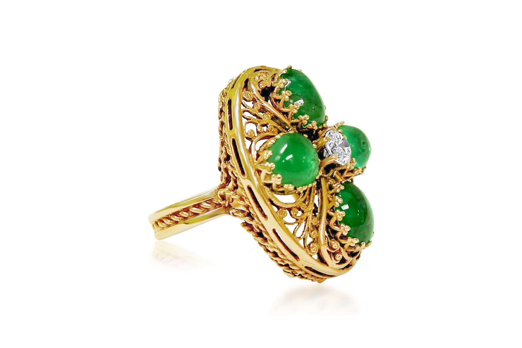 In 14K rose gold, this vintage ring boasts an impressive 8.00 ct cabochon-cut emerald, showcasing its natural beauty. Accompanied by a 1/2 ct round brilliant cut diamond, both gems are set in prongs, exuding timeless charm. With its unique design