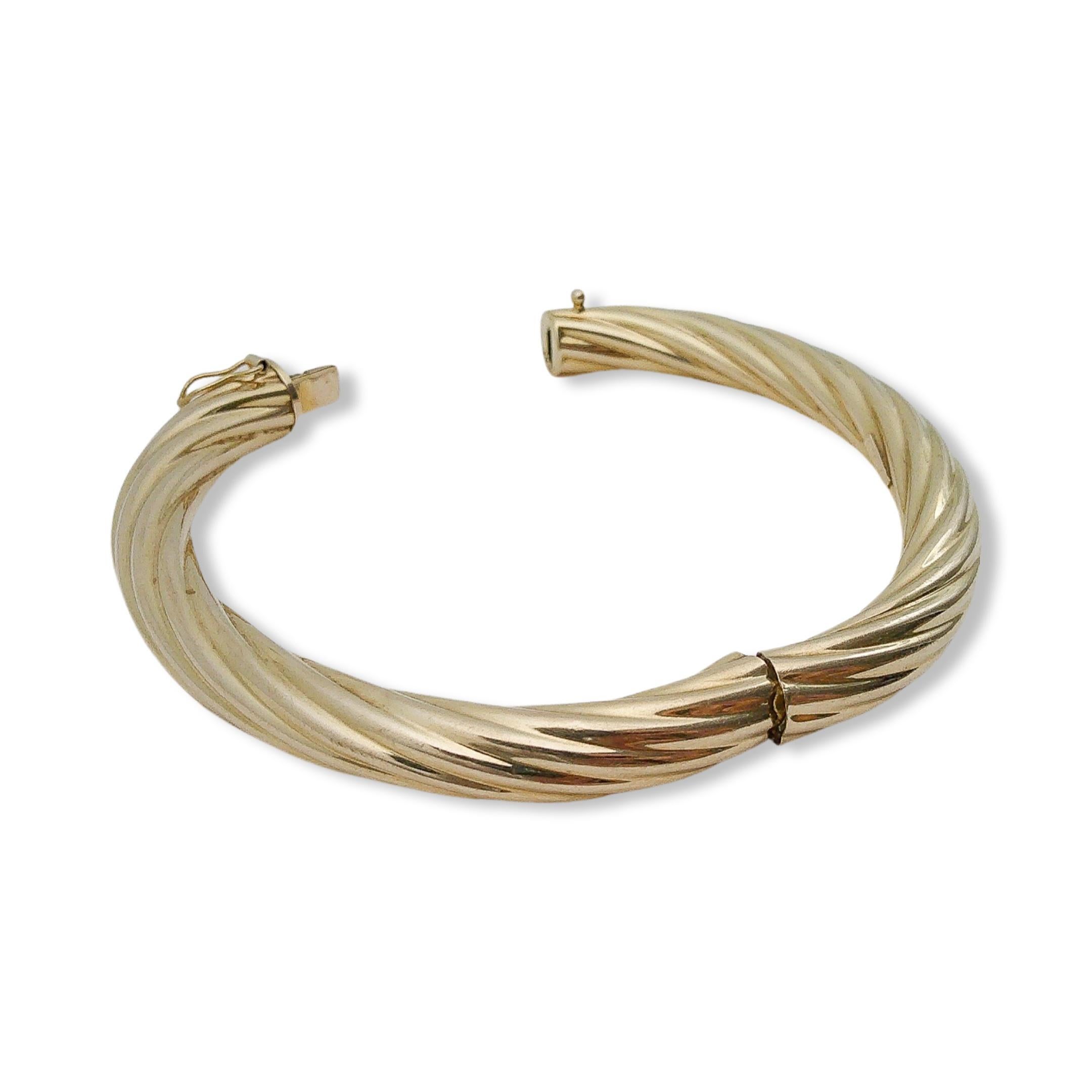 Step into a radiant dance between past and present, where elegance wraps delicately around your wrist in a single, fluid motion. Inspired by the timeless allure of retro aesthetics, this bangle boasts a whimsical twist, spiraling with impeccable