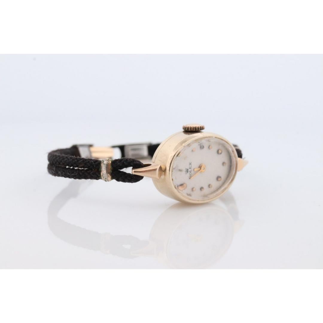 Vintage from the 1950s
Band Material: Gold
Materials: Gold
Power: Mechanical

Readout: Analog

Rolex Ladies Mechanical Movement Wristwatch. Circa 1950s.

Beautiful Watch. Manual Windup mechanism.
Black cable band.

Case is 14k Yellow gold. Clasp is