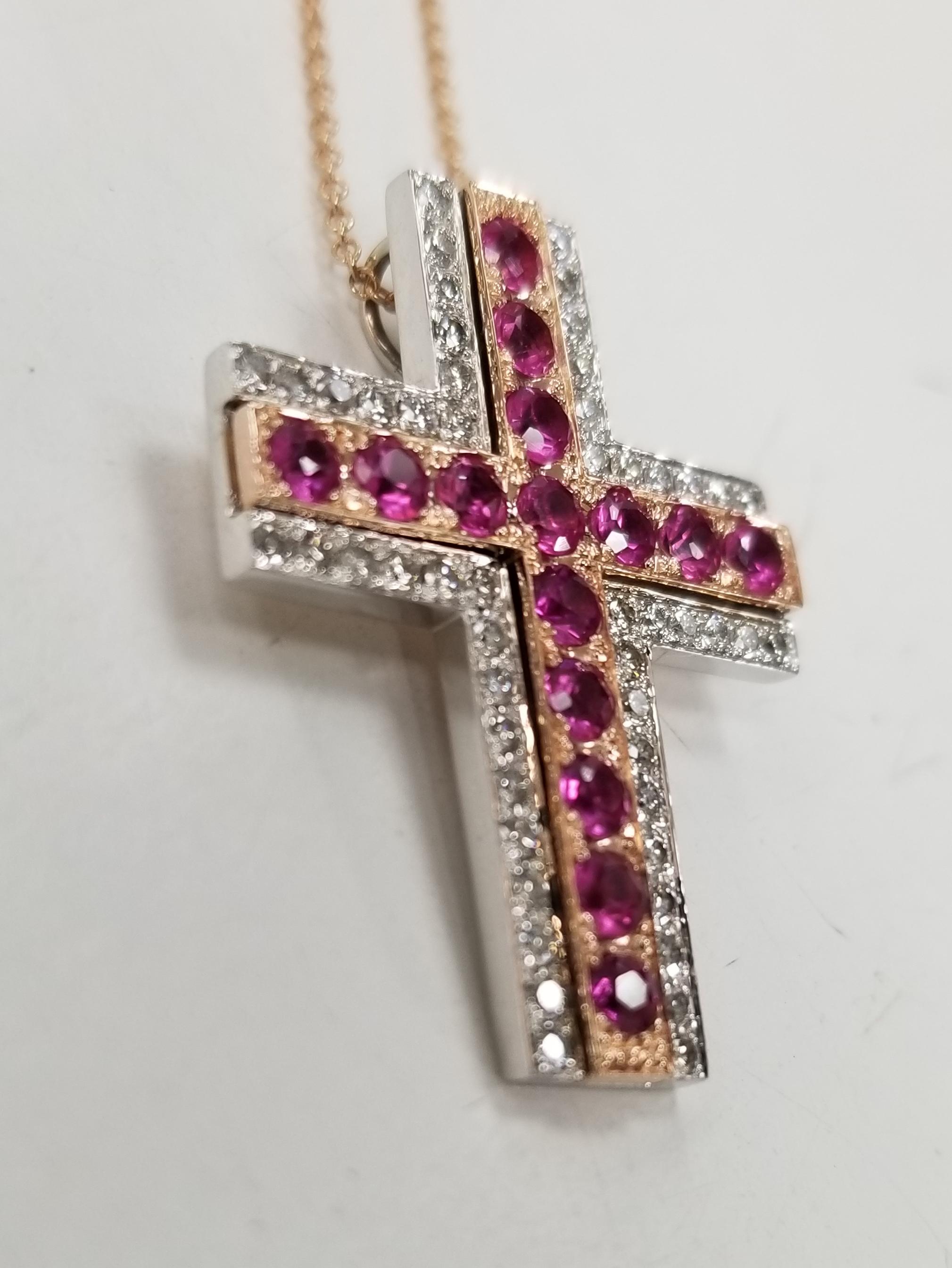 14k rose and white gold ruby and diamond cross, containing 15 round rubies of gem qualiey weighing 1.20cts. and 50 round full cut diamonds of very fine quality weighing .52pts. on a 16 inch chain.