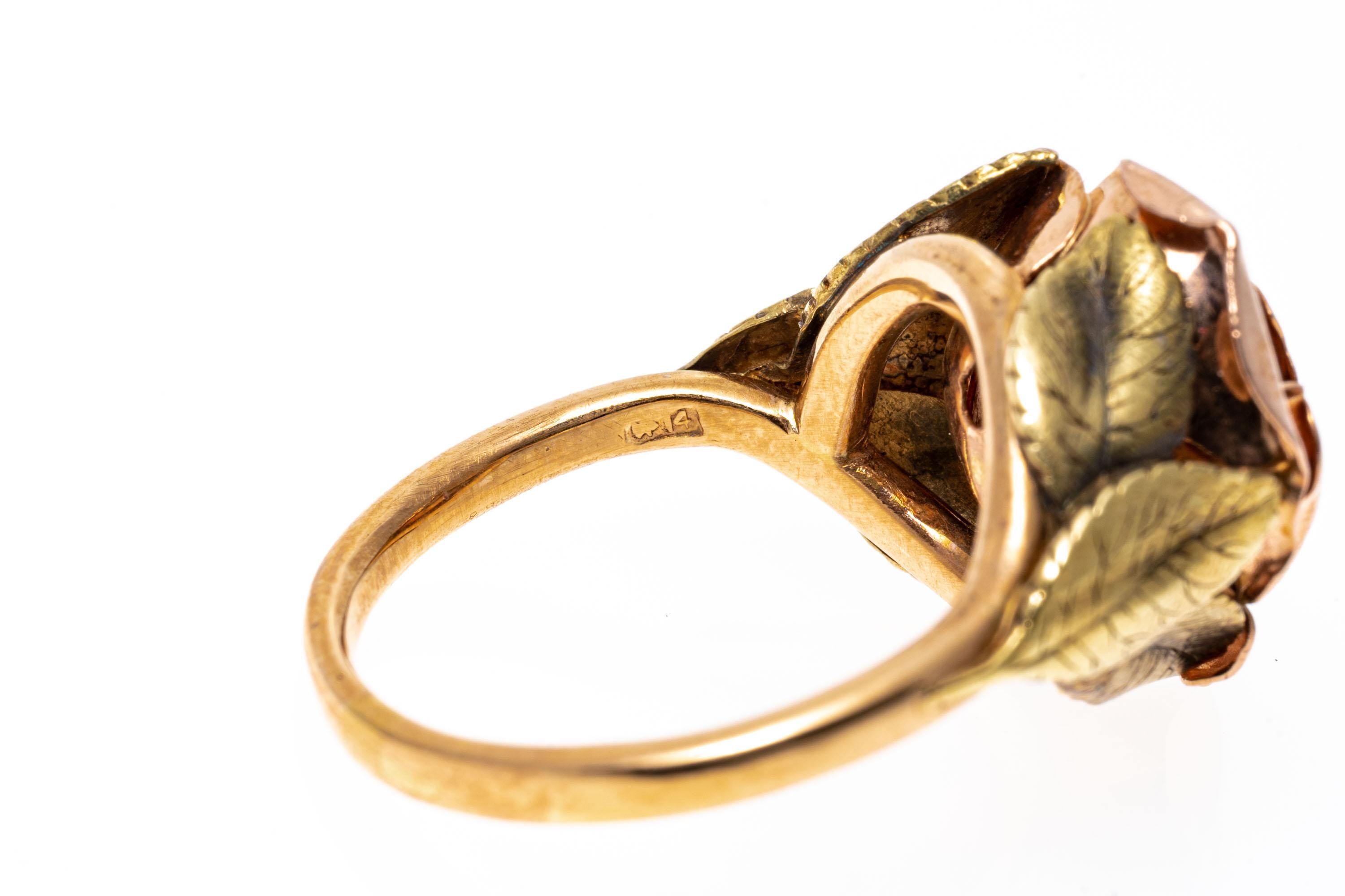 14k rose and yellow gold ring. This charming ring is a figural open rose motif, displayed in rose gold, and flanked by decorated leaf motif shoulders, displayed in yellow gold. The ring is finished with a high polished rose gold shank.
Marks: