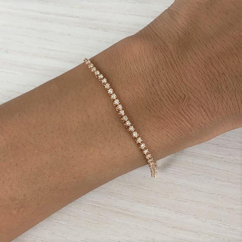 This classic chain tennis bracelet for her features a row of 34 brilliant round diamonds. Crafted of 14k gold, the bracelet has a total diamond weight of 0.50 carats and is adjustable in length 5.5 inches to 7 inches. Diamond color and clarity is Gh